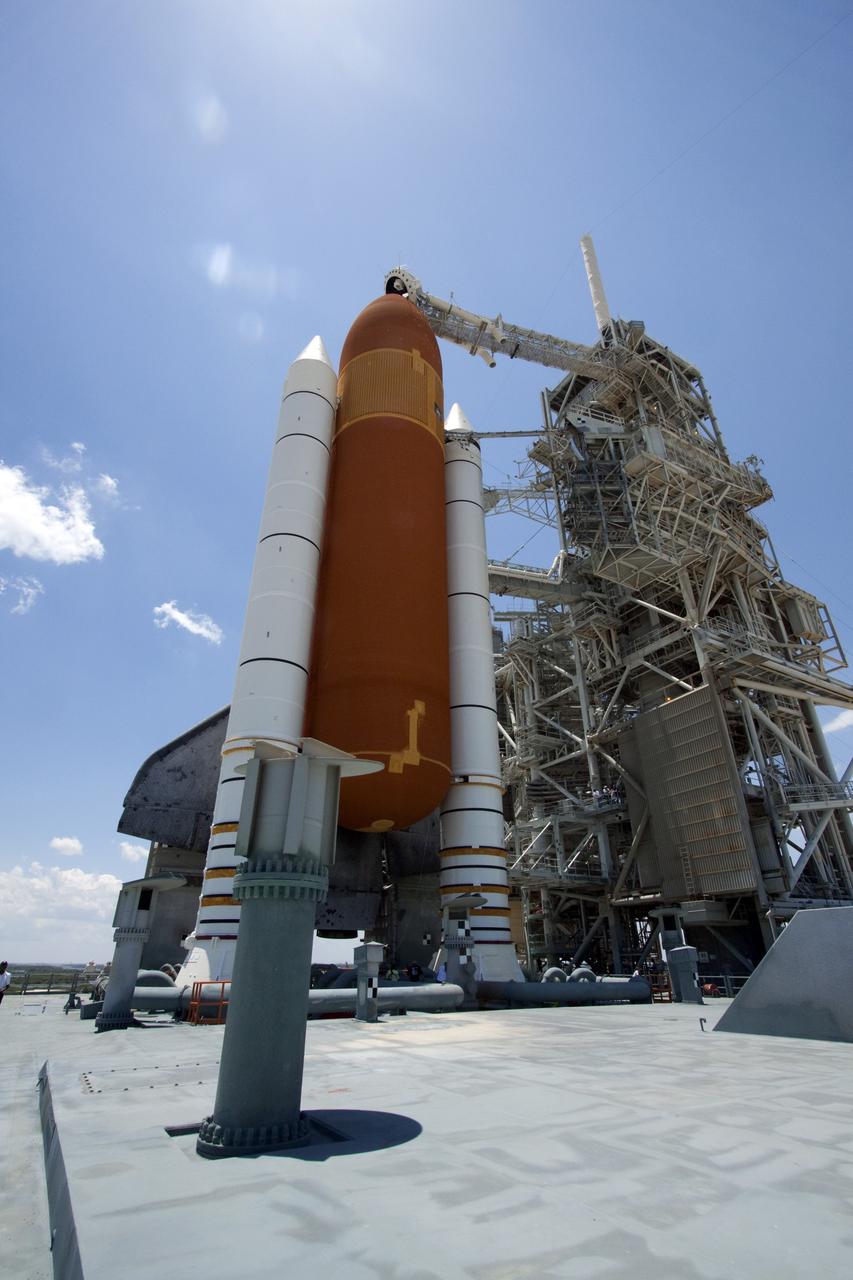 CAPE CANAVERAL, Fla. - The giant external fuel tank and twin solid rocket boosters attached to space shuttle Endeavour bask in the sunlight as the rotating service structure (RSS) moves away on Launch Pad 39A at NASA's Kennedy Space Center in Florida. The structure provides weather protection and access to the shuttle while it awaits lift off on the pad. RSS "rollback," as it's called, began at 11:44 a.m. EDT on May 15 and was completed at 12:24 p.m.     STS-134 will deliver the Alpha Magnetic Spectrometer-2 (AMS), Express Logistics Carrier-3, a high-pressure gas tank and additional spare parts for the Dextre robotic helper to the International Space Station. May 16 at 8:56 a.m. will be the second launch attempt for Endeavour. The first attempt on April 29 was scrubbed because of an issue associated with a faulty power distribution box called the aft load control assembly-2 (ALCA-2). STS-134 will be the final spaceflight for Endeavour. For more information visit, www.nasa.gov/mission_pages/shuttle/shuttlemissions/sts134/index.html. Photo credit: NASA/Jack Pfaller