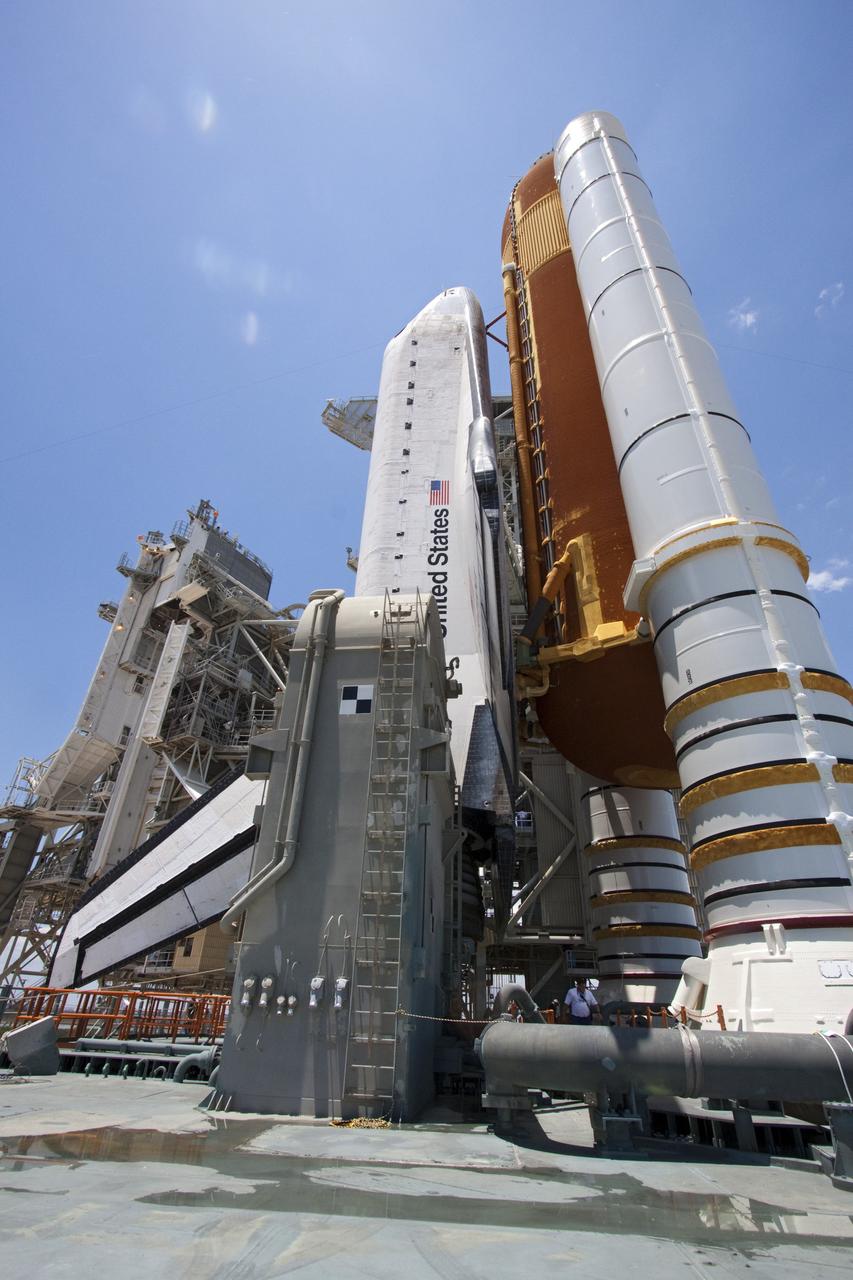 CAPE CANAVERAL, Fla. - Space shuttle Endeavour, the giant external fuel tank and twin solid rocket boosters bask in the sunlight as the rotating service structure (RSS) moves away on Launch Pad 39A at NASA's Kennedy Space Center in Florida. The structure provides weather protection and access to the shuttle while it awaits lift off on the pad. RSS "rollback," as it's called, began at 11:44 a.m. EDT on May 15 and was completed at 12:24 p.m.         STS-134 will deliver the Alpha Magnetic Spectrometer-2 (AMS), Express Logistics Carrier-3, a high-pressure gas tank and additional spare parts for the Dextre robotic helper to the International Space Station. May 16 at 8:56 a.m. will be the second launch attempt for Endeavour. The first attempt on April 29 was scrubbed because of an issue associated with a faulty power distribution box called the aft load control assembly-2 (ALCA-2). STS-134 will be the final spaceflight for Endeavour. For more information visit, www.nasa.gov/mission_pages/shuttle/shuttlemissions/sts134/index.html. Photo credit: NASA/Jack Pfaller