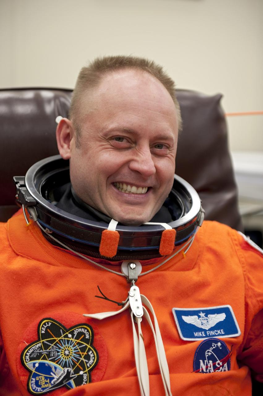 CAPE CANAVERAL, Fla. -- In the Operations and Checkout Building (O&C) at NASA's Kennedy Space Center in Florida, space shuttle Endeavour's STS-134 astronauts put on their launch-and-entry suits and check the fit of their helmets and gloves before heading to the Astrovan for the ride to Launch Pad 39A. Mission Specialist Michael Fincke, seen here, last served as a member of the Expedition 18 crew of the International Space Station in 2009. This will be Fincke's first flight aboard a space shuttle.             STS-134 will deliver the Alpha Magnetic Spectrometer-2 (AMS), Express Logistics Carrier-3, a high-pressure gas tank and additional spare parts for the Dextre robotic helper to the International Space Station. May 16 at 8:56 a.m. will be the second launch attempt for Endeavour. The first attempt on April 29 was scrubbed because of an issue associated with a faulty power distribution box called the aft load control assembly-2 (ALCA-2). STS-134 will be the final spaceflight for Endeavour. For more information visit, www.nasa.gov/mission_pages/shuttle/shuttlemissions/sts134/index.html. Photo credit: NASA/Kim Shiflett