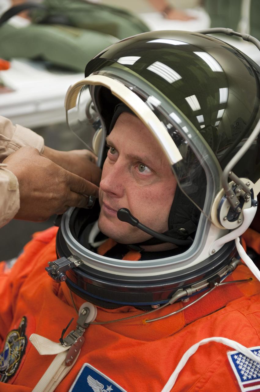CAPE CANAVERAL, Fla. -- In the Operations and Checkout Building (O&C) at NASA's Kennedy Space Center in Florida, space shuttle Endeavour's STS-134 astronauts put on their launch-and-entry suits and check the fit of their helmets and gloves before heading to the Astrovan for the ride to Launch Pad 39A. Mission Specialist Michael Fincke, seen here, last served as a member of the Expedition 18 crew of the International Space Station in 2009. This will be Fincke's first flight aboard a space shuttle.           STS-134 will deliver the Alpha Magnetic Spectrometer-2 (AMS), Express Logistics Carrier-3, a high-pressure gas tank and additional spare parts for the Dextre robotic helper to the International Space Station. May 16 at 8:56 a.m. will be the second launch attempt for Endeavour. The first attempt on April 29 was scrubbed because of an issue associated with a faulty power distribution box called the aft load control assembly-2 (ALCA-2). STS-134 will be the final spaceflight for Endeavour. For more information visit, www.nasa.gov/mission_pages/shuttle/shuttlemissions/sts134/index.html. Photo credit: NASA/Kim Shiflett