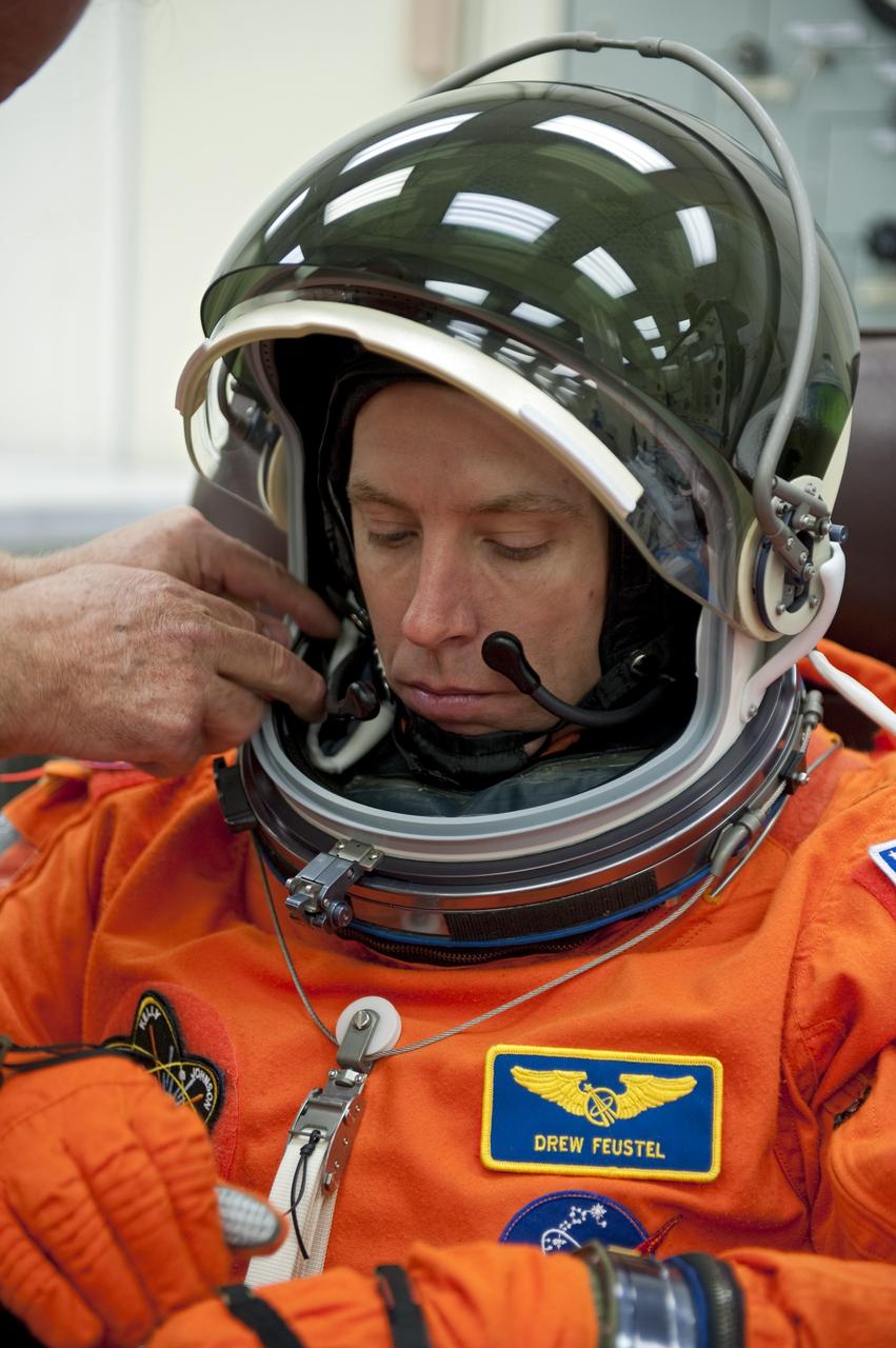 CAPE CANAVERAL, Fla. -- In the Operations and Checkout Building (O&C) at NASA's Kennedy Space Center in Florida, space shuttle Endeavour's STS-134 astronauts put on their launch-and-entry suits and check the fit of their helmets and gloves before heading to the Astrovan for the ride to Launch Pad 39A. Mission Specialist Andrew Feustel, seen here, last flew on a mission to NASA's Hubble Space Telescope in 2009.         STS-134 will deliver the Alpha Magnetic Spectrometer-2 (AMS), Express Logistics Carrier-3, a high-pressure gas tank and additional spare parts for the Dextre robotic helper to the International Space Station. May 16 at 8:56 a.m. will be the second launch attempt for Endeavour. The first attempt on April 29 was scrubbed because of an issue associated with a faulty power distribution box called the aft load control assembly-2 (ALCA-2). STS-134 will be the final spaceflight for Endeavour. For more information visit, www.nasa.gov/mission_pages/shuttle/shuttlemissions/sts134/index.html. Photo credit: NASA/Kim Shiflett