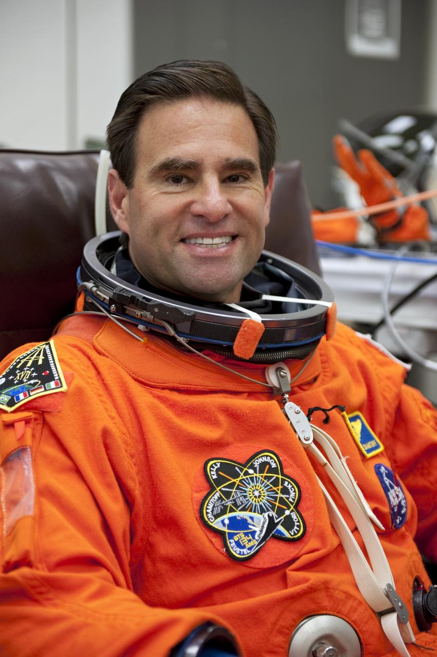 CAPE CANAVERAL, Fla. -- In the Operations and Checkout Building (O&C) at NASA's Kennedy Space Center in Florida, space shuttle Endeavour's STS-134 astronauts put on their launch-and-entry suits and check the fit of their helmets and gloves before heading to the Astrovan for the ride to Launch Pad 39A. Mission Specialist Greg Chamitoff, seen here, last served as flight engineer and science officer aboard the International Space Station in 2008.          STS-134 will deliver the Alpha Magnetic Spectrometer-2 (AMS), Express Logistics Carrier-3, a high-pressure gas tank and additional spare parts for the Dextre robotic helper to the International Space Station. May 16 at 8:56 a.m. will be the second launch attempt for Endeavour. The first attempt on April 29 was scrubbed because of an issue associated with a faulty power distribution box called the aft load control assembly-2 (ALCA-2). STS-134 will be the final spaceflight for Endeavour. For more information visit, www.nasa.gov/mission_pages/shuttle/shuttlemissions/sts134/index.html. Photo credit: NASA/Kim Shiflett