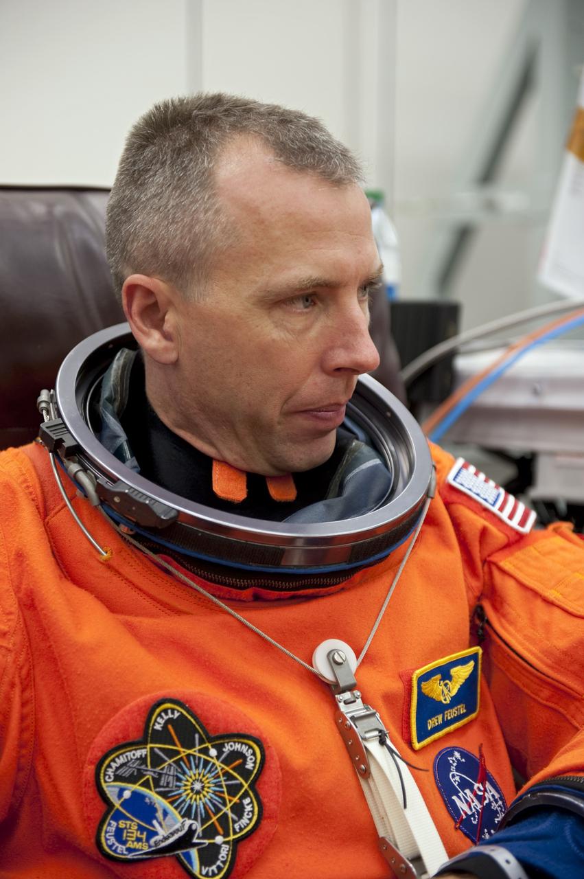 CAPE CANAVERAL, Fla. -- In the Operations and Checkout Building (O&C) at NASA's Kennedy Space Center in Florida, space shuttle Endeavour's STS-134 astronauts put on their launch-and-entry suits and check the fit of their helmets and gloves before heading to the Astrovan for the ride to Launch Pad 39A. Mission Specialist Andrew Feustel, seen here, last flew on a mission to NASA's Hubble Space Telescope in 2009.         STS-134 will deliver the Alpha Magnetic Spectrometer-2 (AMS), Express Logistics Carrier-3, a high-pressure gas tank and additional spare parts for the Dextre robotic helper to the International Space Station. May 16 at 8:56 a.m. will be the second launch attempt for Endeavour. The first attempt on April 29 was scrubbed because of an issue associated with a faulty power distribution box called the aft load control assembly-2 (ALCA-2). STS-134 will be the final spaceflight for Endeavour. For more information visit, www.nasa.gov/mission_pages/shuttle/shuttlemissions/sts134/index.html. Photo credit: NASA/Kim Shiflett