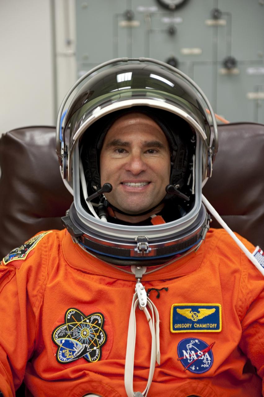 CAPE CANAVERAL, Fla. -- In the Operations and Checkout Building (O&C) at NASA's Kennedy Space Center in Florida, space shuttle Endeavour's STS-134 astronauts put on their launch-and-entry suits and check the fit of their helmets and gloves before heading to the Astrovan for the ride to Launch Pad 39A. Mission Specialist Greg Chamitoff, seen here, last served as flight engineer and science officer aboard the International Space Station in 2008.          STS-134 will deliver the Alpha Magnetic Spectrometer-2 (AMS), Express Logistics Carrier-3, a high-pressure gas tank and additional spare parts for the Dextre robotic helper to the International Space Station. May 16 at 8:56 a.m. will be the second launch attempt for Endeavour. The first attempt on April 29 was scrubbed because of an issue associated with a faulty power distribution box called the aft load control assembly-2 (ALCA-2). STS-134 will be the final spaceflight for Endeavour. For more information visit, www.nasa.gov/mission_pages/shuttle/shuttlemissions/sts134/index.html. Photo credit: NASA/Kim Shiflett