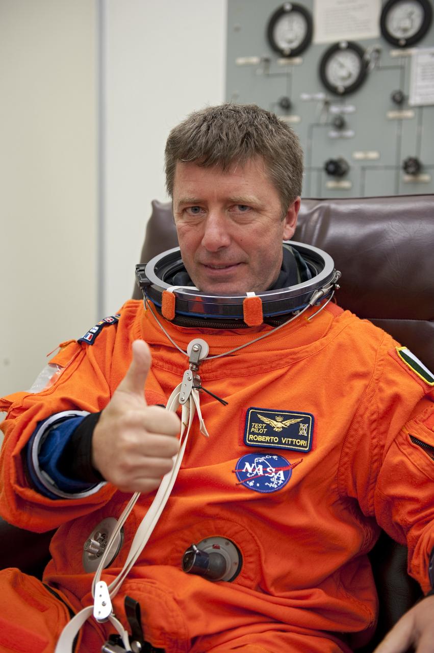 CAPE CANAVERAL, Fla. -- In the Operations and Checkout Building (O&C) at NASA's Kennedy Space Center in Florida, space shuttle Endeavour's STS-134 astronauts put on their launch-and-entry suits and check the fit of their helmets and gloves before heading to the Astrovan for the ride to Launch Pad 39A. Mission Specialist Roberto Vittori with the European Space Agency, seen here, will be making his third trip to the International Space Station. His first mission was in 2002 and second in 2005, both of which were launched aboard a Russian Soyuz spacecraft.       STS-134 will deliver the Alpha Magnetic Spectrometer-2 (AMS), Express Logistics Carrier-3, a high-pressure gas tank and additional spare parts for the Dextre robotic helper to the International Space Station. May 16 at 8:56 a.m. will be the second launch attempt for Endeavour. The first attempt on April 29 was scrubbed because of an issue associated with a faulty power distribution box called the aft load control assembly-2 (ALCA-2). STS-134 will be the final spaceflight for Endeavour. For more information visit, www.nasa.gov/mission_pages/shuttle/shuttlemissions/sts134/index.html. Photo credit: NASA/Kim Shiflett