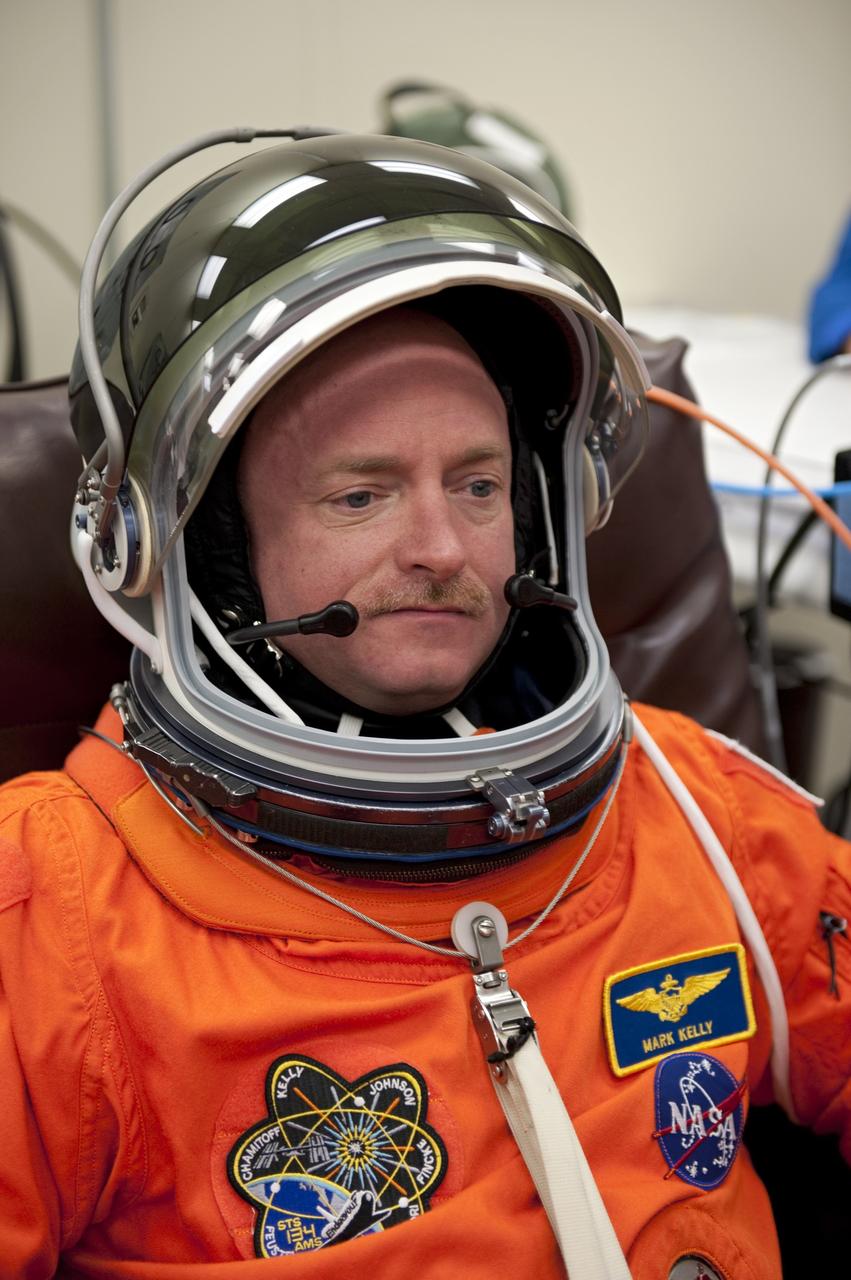CAPE CANAVERAL, Fla. -- In the Operations and Checkout Building (O&C) at NASA's Kennedy Space Center in Florida, space shuttle Endeavour's STS-134 astronauts put on their launch-and-entry suits and check the fit of their helmets and gloves before heading to the Astrovan for the ride to Launch Pad 39A. Commander Mark Kelly, seen here, last commanded space shuttle Discovery during its STS-124 mission in 2008.     STS-134 will deliver the Alpha Magnetic Spectrometer-2 (AMS), Express Logistics Carrier-3, a high-pressure gas tank and additional spare parts for the Dextre robotic helper to the International Space Station. May 16 at 8:56 a.m. will be the second launch attempt for Endeavour. The first attempt on April 29 was scrubbed because of an issue associated with a faulty power distribution box called the aft load control assembly-2 (ALCA-2). STS-134 will be the final spaceflight for Endeavour. For more information visit, www.nasa.gov/mission_pages/shuttle/shuttlemissions/sts134/index.html. Photo credit: NASA/Kim Shiflett
