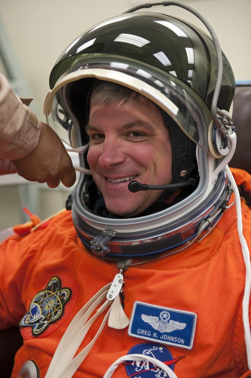 CAPE CANAVERAL, Fla. -- In the Operations and Checkout Building (O&C) at NASA's Kennedy Space Center in Florida, space shuttle Endeavour's STS-134 astronauts put on their launch-and-entry suits and check the fit of their helmets and gloves before heading to the Astrovan for the ride to Launch Pad 39A. Pilot Greg H. Johnson, seen here, last piloted space shuttle Endeavour during its STS-123 mission in 2008.         STS-134 will deliver the Alpha Magnetic Spectrometer-2 (AMS), Express Logistics Carrier-3, a high-pressure gas tank and additional spare parts for the Dextre robotic helper to the International Space Station. May 16 at 8:56 a.m. will be the second launch attempt for Endeavour. The first attempt on April 29 was scrubbed because of an issue associated with a faulty power distribution box called the aft load control assembly-2 (ALCA-2). STS-134 will be the final spaceflight for Endeavour. For more information visit, www.nasa.gov/mission_pages/shuttle/shuttlemissions/sts134/index.html. Photo credit: NASA/Kim Shiflett