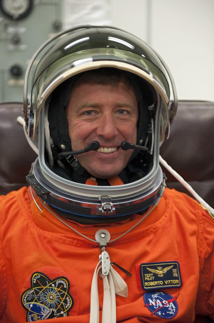 CAPE CANAVERAL, Fla. -- In the Operations and Checkout Building (O&C) at NASA's Kennedy Space Center in Florida, space shuttle Endeavour's STS-134 astronauts put on their launch-and-entry suits and check the fit of their helmets and gloves before heading to the Astrovan for the ride to Launch Pad 39A. Mission Specialist Roberto Vittori with the European Space Agency, seen here, will be making his third trip to the International Space Station. His first mission was in 2002 and second in 2005, both of which were launched aboard a Russian Soyuz spacecraft.       STS-134 will deliver the Alpha Magnetic Spectrometer-2 (AMS), Express Logistics Carrier-3, a high-pressure gas tank and additional spare parts for the Dextre robotic helper to the International Space Station. May 16 at 8:56 a.m. will be the second launch attempt for Endeavour. The first attempt on April 29 was scrubbed because of an issue associated with a faulty power distribution box called the aft load control assembly-2 (ALCA-2). STS-134 will be the final spaceflight for Endeavour. For more information visit, www.nasa.gov/mission_pages/shuttle/shuttlemissions/sts134/index.html. Photo credit: NASA/Kim Shiflett