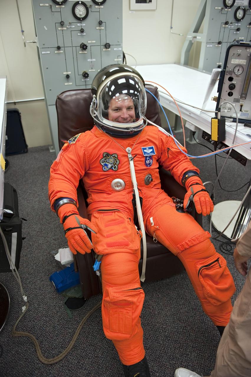 CAPE CANAVERAL, Fla. -- In the Operations and Checkout Building (O&C) at NASA's Kennedy Space Center in Florida, space shuttle Endeavour's STS-134 astronauts put on their launch-and-entry suits and check the fit of their helmets and gloves before heading to the Astrovan for the ride to Launch Pad 39A. Pilot Greg H. Johnson, seen here, last piloted space shuttle Endeavour during its STS-123 mission in 2008.     STS-134 will deliver the Alpha Magnetic Spectrometer-2 (AMS), Express Logistics Carrier-3, a high-pressure gas tank and additional spare parts for the Dextre robotic helper to the International Space Station. May 16 at 8:56 a.m. will be the second launch attempt for Endeavour. The first attempt on April 29 was scrubbed because of an issue associated with a faulty power distribution box called the aft load control assembly-2 (ALCA-2). STS-134 will be the final spaceflight for Endeavour. For more information visit, www.nasa.gov/mission_pages/shuttle/shuttlemissions/sts134/index.html. Photo credit: NASA/Kim Shiflett
