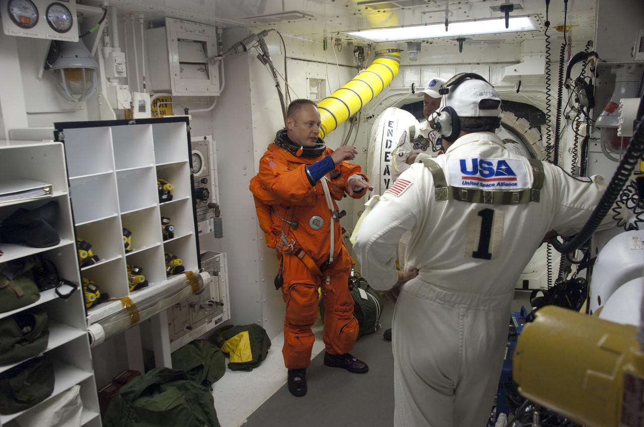 CAPE CANAVERAL, Fla. -- In the White Room at Launch Pad 39A at NASA's Kennedy Space Center in Florida, STS-134 Mission Specialist Michael Fincke prepares to board space shuttle Endeavour through the crew hatch in the background. Members of the Closeout Crew, in white uniforms, are there to assist astronauts with their launch-and-entry suits and the boarding process. Fincke last served as a member of the Expedition 18 crew of the International Space Station in 2009. This will be Fincke's first flight aboard a space shuttle.        STS-134 will deliver the Alpha Magnetic Spectrometer-2 (AMS), Express Logistics Carrier-3, a high-pressure gas tank and additional spare parts for the Dextre robotic helper to the International Space Station. May 16 at 8:56 a.m. will be the second launch attempt for Endeavour. The first attempt on April 29 was scrubbed because of an issue associated with a faulty power distribution box called the aft load control assembly-2 (ALCA-2). STS-134 will be the final spaceflight for Endeavour. For more information visit, www.nasa.gov/mission_pages/shuttle/shuttlemissions/sts134/index.html. Photo credit: NASA/Sandra Joseph and Kevin O'Connell