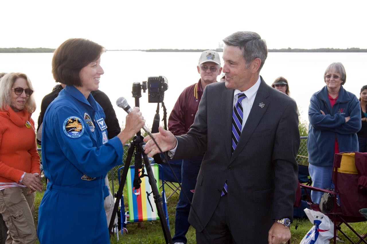CAPE CANAVERAL, Fla. - NASA astronaut Shannon Walker, left and Kennedy Space Center Director Bob Cabana talk to a crowd of spectators gathered at the Banana Creek Viewing Site near the Saturn V Center at NASA's Kennedy Space Center in Florida to watch the launch of space shuttle Endeavour. The shuttle lifted off on its STS-134 mission to the International Space Station on time at 8:56 a.m. EDT on May 16.    The shuttle and its six-member crew are embarking on a mission to deliver the Alpha Magnetic Spectrometer-2 (AMS), Express Logistics Carrier-3, a high-pressure gas tank and additional spare parts for the Dextre robotic helper to the space station. Endeavour's first launch attempt on April 29 was scrubbed because of an issue associated with a faulty power distribution box called the aft load control assembly-2 (ALCA-2). For more information, visit www.nasa.gov/mission_pages/shuttle/shuttlemissions/sts134/index.html. Photo credit: NASA/Chad Baumer