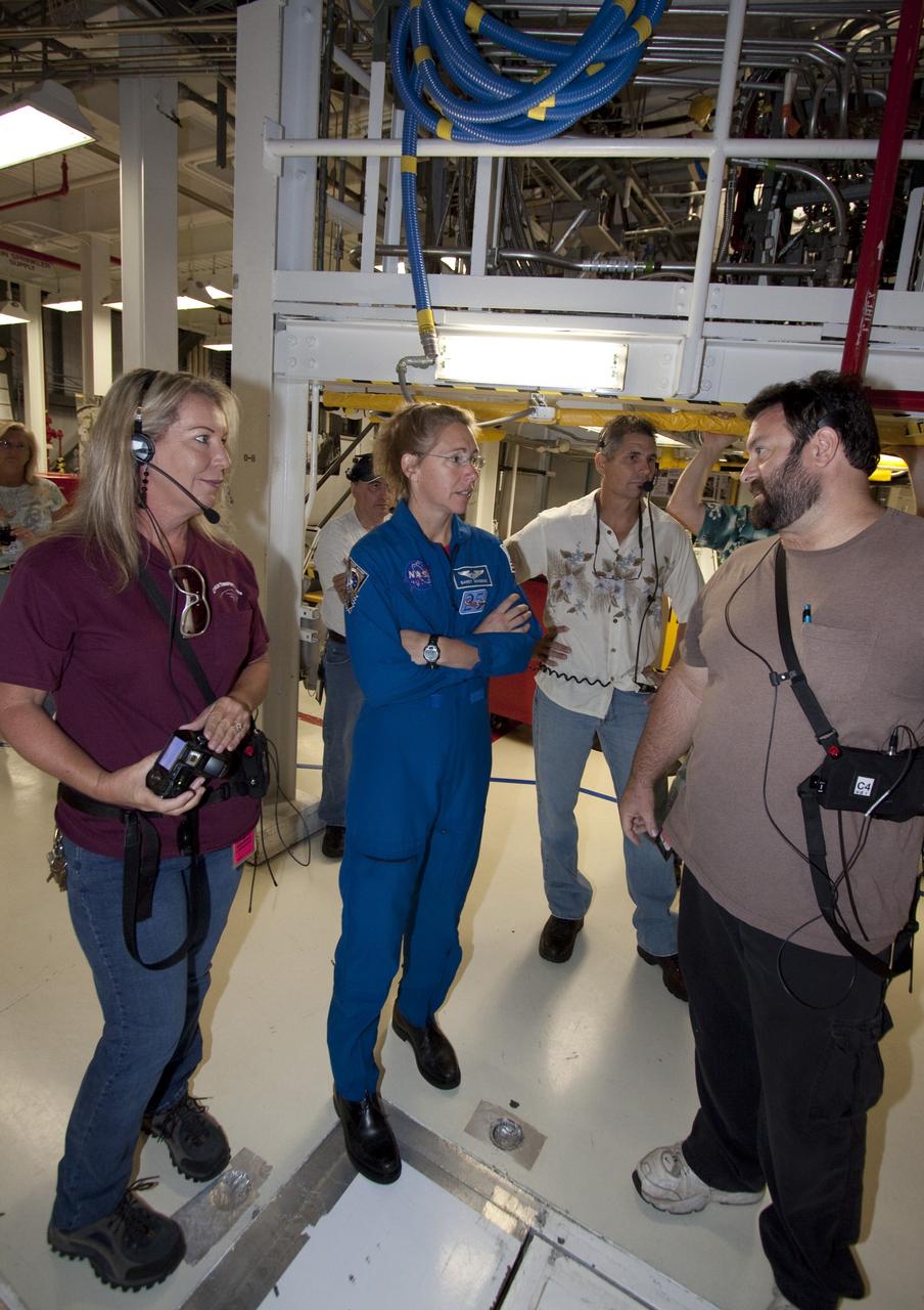 CAPE CANAVERAL, Fla. -- STS-135 Mission Specialist Sandra Magnus talks with technicians in Orbiter Processing Facility-1 prior shuttle Atlantis' final planned move to the Vehicle Assembly Building at NASA's Kennedy Space Center in Florida. The move called "rollover" is a major milestone in processing for the STS-135 mission to the International Space Station. Inside the VAB, the shuttle will be attached to its external fuel tank and solid rocket boosters. Magnus, along with Commander Chris Ferguson, Pilot Doug Hurley and Mission Specialist Rex Walheim are targeted to launch in early July, taking with them the Raffaello multipurpose logistics module packed with supplies, logistics and spare parts. The STS-135 mission also will fly a system to investigate the potential for robotically refueling existing spacecraft and return a failed ammonia pump module to help NASA better understand the failure mechanism and improve pump designs for future systems.                STS-135 will be the 33rd flight of Atlantis, the 37th shuttle mission to the space station, and the 135th and final mission of NASA's Space Shuttle Program. For more information visit, www.nasa.gov/mission_pages/shuttle/shuttlemissions/sts135/index.html. Photo credit: NASA/Jack Pfaller