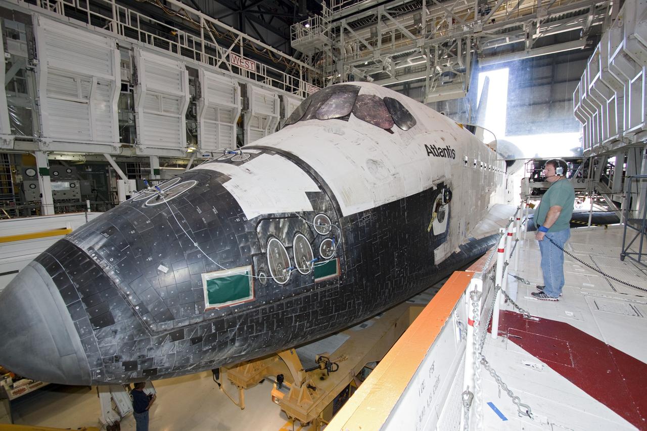 CAPE CANAVERAL, Fla. -- Technicians prepare shuttle Atlantis for its final planned move from Orbiter Processing Facility-1 to the Vehicle Assembly Building at NASA's Kennedy Space Center in Florida. The move called "rollover" is a major milestone in processing for the STS-135 mission to the International Space Station. Inside the VAB, the shuttle will be attached to its external fuel tank and solid rocket boosters. Commander Chris Ferguson, Pilot Doug Hurley and Mission Specialists Sandra Magnus and Rex Walheim are targeted to launch in early July, taking with them the Raffaello multipurpose logistics module packed with supplies, logistics and spare parts. The STS-135 mission also will fly a system to investigate the potential for robotically refueling existing spacecraft and return a failed ammonia pump module to help NASA better understand the failure mechanism and improve pump designs for future systems.              STS-135 will be the 33rd flight of Atlantis, the 37th shuttle mission to the space station, and the 135th and final mission of NASA's Space Shuttle Program. For more information visit, www.nasa.gov/mission_pages/shuttle/shuttlemissions/sts135/index.html. Photo credit: NASA/Jack Pfaller