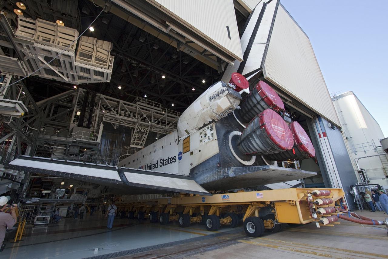 CAPE CANAVERAL, Fla. -- Shuttle Atlantis slowly backs out of Orbiter Processing Facility-1 during its final planned move to the Vehicle Assembly Building at NASA's Kennedy Space Center in Florida. The move called "rollover" is a major milestone in processing for the STS-135 mission to the International Space Station. Inside the VAB, the shuttle will be attached to its external fuel tank and solid rocket boosters. Commander Chris Ferguson, Pilot Doug Hurley and Mission Specialists Sandra Magnus and Rex Walheim are targeted to launch in early July, taking with them the Raffaello multipurpose logistics module packed with supplies, logistics and spare parts. The STS-135 mission also will fly a system to investigate the potential for robotically refueling existing spacecraft and return a failed ammonia pump module to help NASA better understand the failure mechanism and improve pump designs for future systems.          STS-135 will be the 33rd flight of Atlantis, the 37th shuttle mission to the space station, and the 135th and final mission of NASA's Space Shuttle Program. For more information visit, www.nasa.gov/mission_pages/shuttle/shuttlemissions/sts135/index.html. Photo credit: NASA/Jack Pfaller