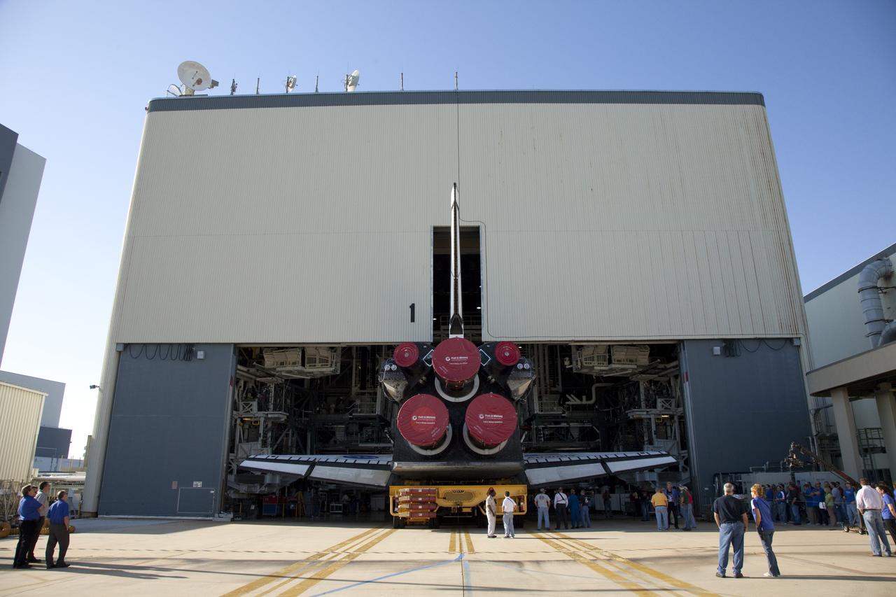 CAPE CANAVERAL, Fla. -- Shuttle Atlantis slowly backs out of Orbiter Processing Facility-1 during its final planned move to the Vehicle Assembly Building (VAB) at NASA's Kennedy Space Center in Florida.          The move called "rollover" is a major milestone in processing for the STS-135 mission to the International Space Station. Inside the VAB, the shuttle will be attached to its external fuel tank and solid rocket boosters. Commander Chris Ferguson, Pilot Doug Hurley and Mission Specialists Sandra Magnus and Rex Walheim are targeted to launch in early July, taking with them the Raffaello multipurpose logistics module packed with supplies, logistics and spare parts. The STS-135 mission also will fly a system to investigate the potential for robotically refueling existing spacecraft and return a failed ammonia pump module to help NASA better understand the failure mechanism and improve pump designs for future systems. STS-135 will be the 33rd flight of Atlantis, the 37th shuttle mission to the space station, and the 135th and final mission of NASA's Space Shuttle Program. For more information visit, www.nasa.gov/mission_pages/shuttle/shuttlemissions/sts135/index.html. Photo credit: NASA/Frankie Martin