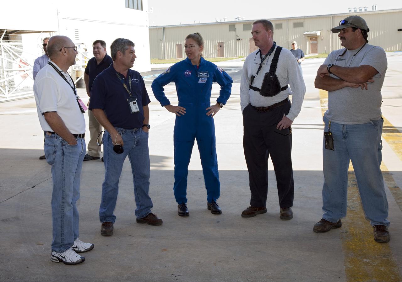 CAPE CANAVERAL, Fla. -- Outside of Orbiter Processing Facility-1 at NASA's Kennedy Space Center in Florida, STS-135 Mission Specialist Sandra Magnus speaks with Kennedy employees while shuttle Atlantis is being moved to the Vehicle Assembly Building (VAB).        The move called "rollover" is a major milestone in processing for the STS-135 mission to the International Space Station. Inside the VAB, the shuttle will be attached to its external fuel tank and solid rocket boosters. Commander Chris Ferguson, Pilot Doug Hurley and Mission Specialists Sandra Magnus and Rex Walheim are targeted to launch in early July, taking with them the Raffaello multipurpose logistics module packed with supplies, logistics and spare parts. The STS-135 mission also will fly a system to investigate the potential for robotically refueling existing spacecraft and return a failed ammonia pump module to help NASA better understand the failure mechanism and improve pump designs for future systems. STS-135 will be the 33rd flight of Atlantis, the 37th shuttle mission to the space station, and the 135th and final mission of NASA's Space Shuttle Program. For more information visit, www.nasa.gov/mission_pages/shuttle/shuttlemissions/sts135/index.html. Photo credit: NASA/Frankie Martin