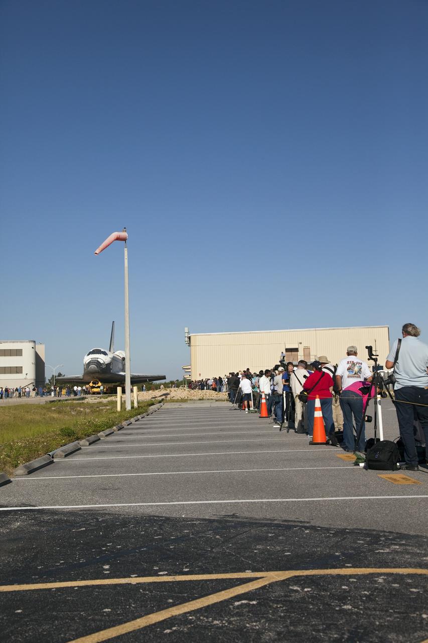 CAPE CANAVERAL, Fla. -- Members of the media and Kennedy workers snap photos of shuttle Atlantis as it makes its final planned move from Orbiter Processing Facility-1 to the Vehicle Assembly Building (VAB) at NASA's Kennedy Space Center in Florida.        The move called "rollover" is a major milestone in processing for the STS-135 mission to the International Space Station. Inside the VAB, the shuttle will be attached to its external fuel tank and solid rocket boosters. Commander Chris Ferguson, Pilot Doug Hurley and Mission Specialists Sandra Magnus and Rex Walheim are targeted to launch in early July, taking with them the Raffaello multipurpose logistics module packed with supplies, logistics and spare parts. The STS-135 mission also will fly a system to investigate the potential for robotically refueling existing spacecraft and return a failed ammonia pump module to help NASA better understand the failure mechanism and improve pump designs for future systems. STS-135 will be the 33rd flight of Atlantis, the 37th shuttle mission to the space station, and the 135th and final mission of NASA's Space Shuttle Program. For more information visit, www.nasa.gov/mission_pages/shuttle/shuttlemissions/sts135/index.html. Photo credit: NASA/Frankie Martin
