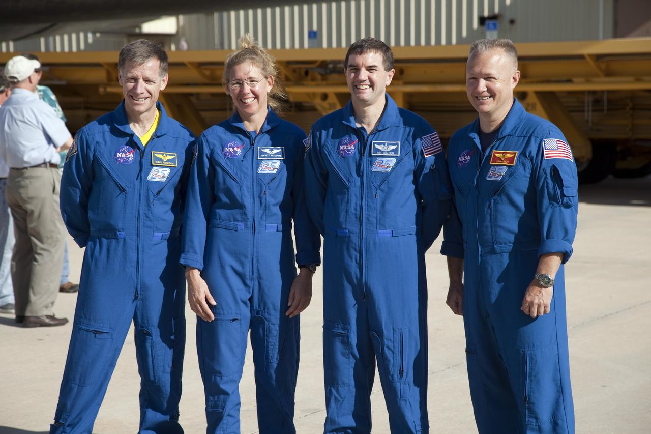 CAPE CANAVERAL, Fla. -- STS-135 Commander Chris Ferguson, Mission Specialists Sandra Magnus and Rex Walheim, and Pilot Doug Hurley pause for a photo while watching Atlantis' rollover from Orbiter Processing Facility-1 to the Vehicle Assembly Building (VAB) at NASA's Kennedy Space Center in Florida.      The move called "rollover" is a major milestone in processing for the STS-135 mission to the International Space Station. Inside the VAB, the shuttle will be attached to its external fuel tank and solid rocket boosters. Commander Chris Ferguson, Pilot Doug Hurley and Mission Specialists Sandra Magnus and Rex Walheim are targeted to launch in early July, taking with them the Raffaello multipurpose logistics module packed with supplies, logistics and spare parts. The STS-135 mission also will fly a system to investigate the potential for robotically refueling existing spacecraft and return a failed ammonia pump module to help NASA better understand the failure mechanism and improve pump designs for future systems. STS-135 will be the 33rd flight of Atlantis, the 37th shuttle mission to the space station, and the 135th and final mission of NASA's Space Shuttle Program. For more information visit, www.nasa.gov/mission_pages/shuttle/shuttlemissions/sts135/index.html. Photo credit: NASA/Frankie Martin