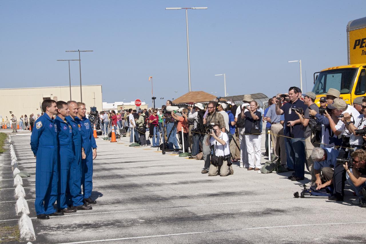 CAPE CANAVERAL, Fla. -- Members of the media and NASA Kennedy Space Center workers snap photos of the STS-135 crew members who are at the center to watch shuttle Atlantis make its final planned move from Orbiter Processing Facility-1 to the Vehicle Assembly Building. From left, are Mission Specialist Rex Walheim, Commander Chris Ferguson, Pilot Doug Hurley and Mission Specialist Sandra Magnus. The move called "rollover" is a major milestone in processing for the STS-135 mission, which will deliver the Raffaello multipurpose logistics module packed with supplies, logistics and spare parts to the International Space Station. Targeted to launch in early July, STS-135 also will fly a system to investigate the potential for robotically refueling existing spacecraft and return a failed ammonia pump module to help NASA better understand the failure mechanism and improve pump designs for future systems. Inside the VAB, the shuttle will be attached to its external fuel tank and solid rocket boosters.        STS-135 will be the 33rd flight of Atlantis, the 37th shuttle mission to the space station, and the 135th and final mission of NASA's Space Shuttle Program. For more information visit, www.nasa.gov/mission_pages/shuttle/shuttlemissions/sts135/index.html. Photo credit: NASA/Jack Pfaller