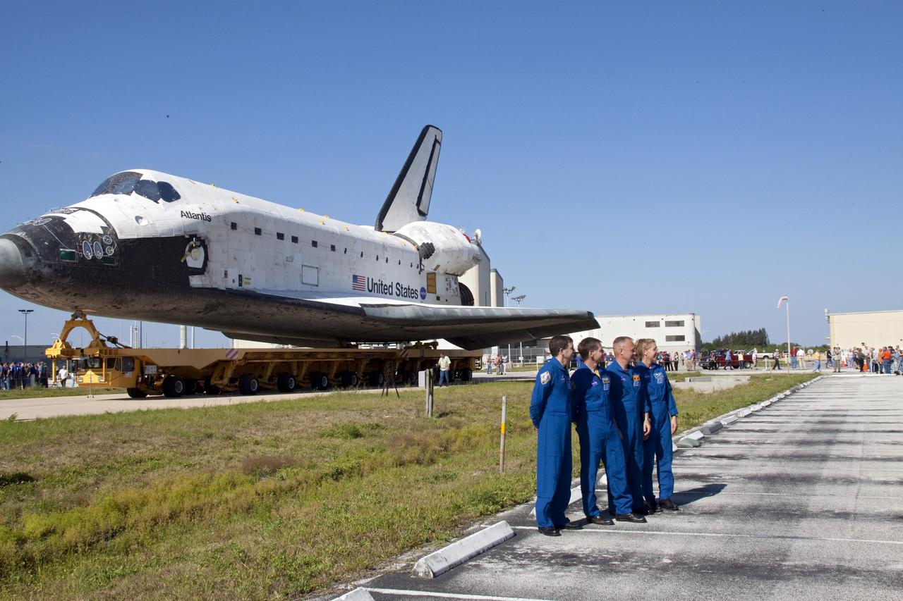 CAPE CANAVERAL, Fla. -- The STS-135 crew members pose for a photo in front of shuttle Atlantis, which is making its final planned trek from Orbiter Processing Facility-1 to the Vehicle Assembly Building. From left, are Mission Specialist Rex Walheim, Commander Chris Ferguson, Pilot Doug Hurley and Mission Specialist Sandra Magnus. The move called "rollover" is a major milestone in processing for the STS-135 mission, which will deliver the Raffaello multipurpose logistics module packed with supplies, logistics and spare parts to the International Space Station. Targeted to launch in early July, STS-135 also will fly a system to investigate the potential for robotically refueling existing spacecraft and return a failed ammonia pump module to help NASA better understand the failure mechanism and improve pump designs for future systems. Inside the VAB, the shuttle will be attached to its external fuel tank and solid rocket boosters.    STS-135 will be the 33rd flight of Atlantis, the 37th shuttle mission to the space station, and the 135th and final mission of NASA's Space Shuttle Program. For more information visit, www.nasa.gov/mission_pages/shuttle/shuttlemissions/sts135/index.html. Photo credit: NASA/Jack Pfaller