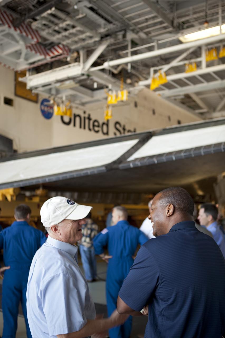 CAPE CANAVERAL, Fla. -- STS-135 Assistant Launch Director Pete Nickolenko and Kennedy's Associate Director for Business Operations Kelvin Manning, enjoy a lighthearted moment while watching shuttle Atlantis as it slowly backs out of Orbiter Processing Facility-1 during its final planned move to the Vehicle Assembly Building (VAB) at NASA's Kennedy Space Center in Florida.          The move called "rollover" is a major milestone in processing for the STS-135 mission to the International Space Station. Inside the VAB, the shuttle will be attached to its external fuel tank and solid rocket boosters. Commander Chris Ferguson, Pilot Doug Hurley and Mission Specialists Sandra Magnus and Rex Walheim are expected to launch in mid July, taking with them the Raffaello multipurpose logistics module packed with supplies, logistics and spare parts. The STS-135 mission also will fly a system to investigate the potential for robotically refueling existing spacecraft and return a failed ammonia pump module to help NASA better understand the failure mechanism and improve pump designs for future systems. STS-135 will be the 33rd flight of Atlantis, the 37th shuttle mission to the space station, and the 135th and final mission of NASA's Space Shuttle Program. For more information visit, www.nasa.gov/mission_pages/shuttle/shuttlemissions/sts135/index.html. Photo credit: NASA/Dimitri Gerondidakis