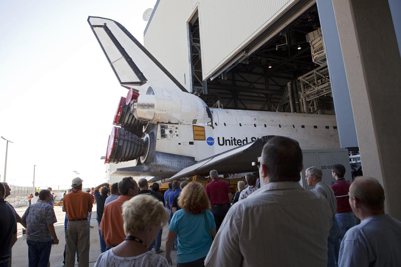 CAPE CANAVERAL, Fla. -- Outside of Orbiter Processing Facility-1 at NASA's Kennedy Space Center in Florida, Kennedy employees and media gather to view shuttle Atlantis as it is being moved to the Vehicle Assembly Building (VAB).        The move called "rollover" is a major milestone in processing for the STS-135 mission to the International Space Station. Inside the VAB, the shuttle will be attached to its external fuel tank and solid rocket boosters. Commander Chris Ferguson, Pilot Doug Hurley and Mission Specialists Sandra Magnus and Rex Walheim are expected to launch in mid July, taking with them the Raffaello multipurpose logistics module packed with supplies, logistics and spare parts. The STS-135 mission also will fly a system to investigate the potential for robotically refueling existing spacecraft and return a failed ammonia pump module to help NASA better understand the failure mechanism and improve pump designs for future systems. STS-135 will be the 33rd flight of Atlantis, the 37th shuttle mission to the space station, and the 135th and final mission of NASA's Space Shuttle Program. For more information visit, www.nasa.gov/mission_pages/shuttle/shuttlemissions/sts135/index.html. Photo credit: NASA/Dimitri Gerondidakis