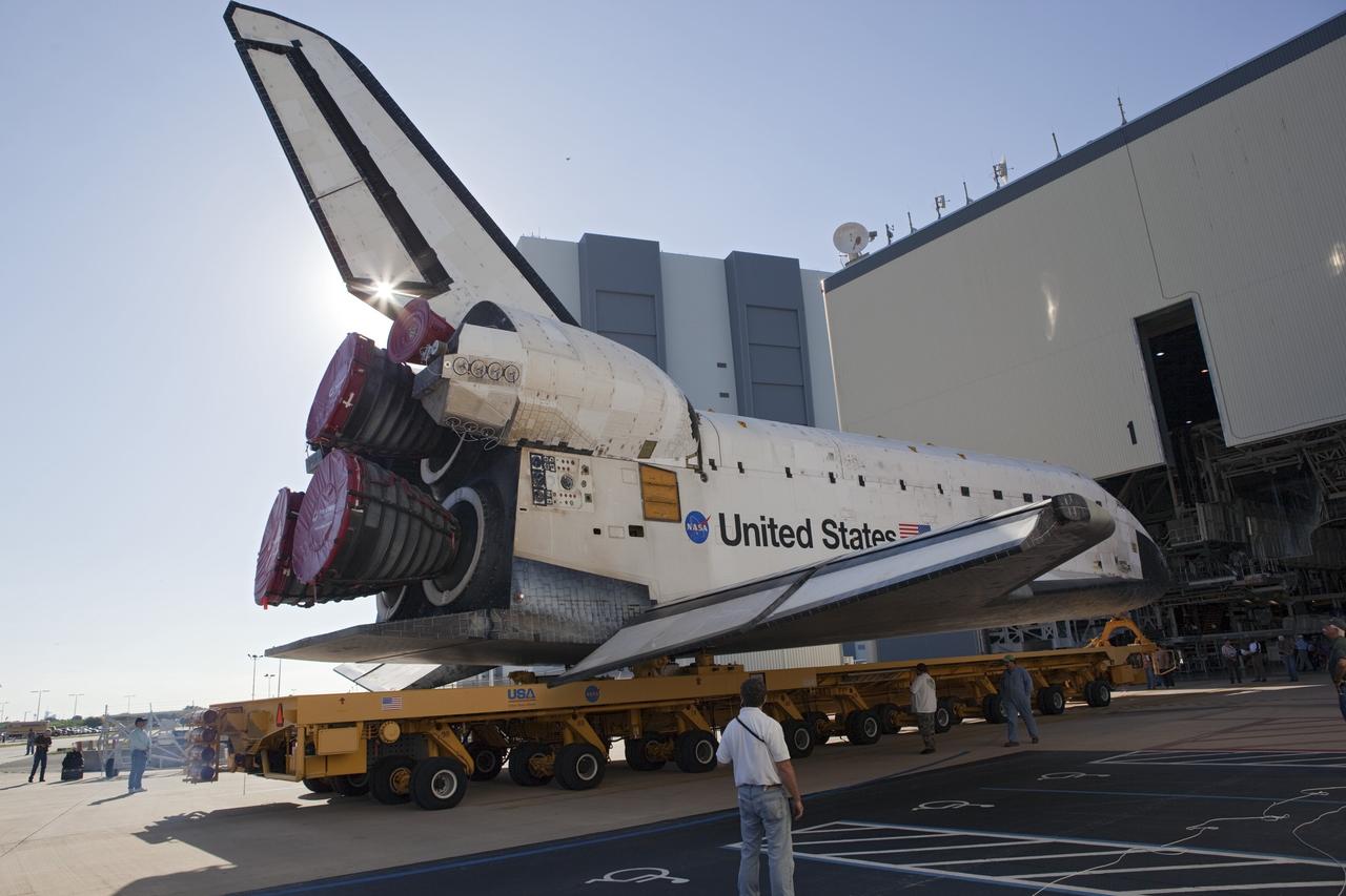 CAPE CANAVERAL, Fla. -- Workers monitor the progress of shuttle Atlantis as it is backing out of Orbiter Processing Faciity-1 on its final planned move to the Vehicle Assembly Building (VAB) at NASA's Kennedy Space Center in Florida.      The move called "rollover" is a major milestone in processing for the STS-135 mission to the International Space Station. Inside the VAB, the shuttle will be attached to its external fuel tank and solid rocket boosters. Commander Chris Ferguson, Pilot Doug Hurley and Mission Specialists Sandra Magnus and Rex Walheim are expected to launch in mid July, taking with them the Raffaello multipurpose logistics module packed with supplies, logistics and spare parts. The STS-135 mission also will fly a system to investigate the potential for robotically refueling existing spacecraft and return a failed ammonia pump module to help NASA better understand the failure mechanism and improve pump designs for future systems. STS-135 will be the 33rd flight of Atlantis, the 37th shuttle mission to the space station, and the 135th and final mission of NASA's Space Shuttle Program. For more information visit, www.nasa.gov/mission_pages/shuttle/shuttlemissions/sts135/index.html. Photo credit: NASA/Dimitri Gerondidakis