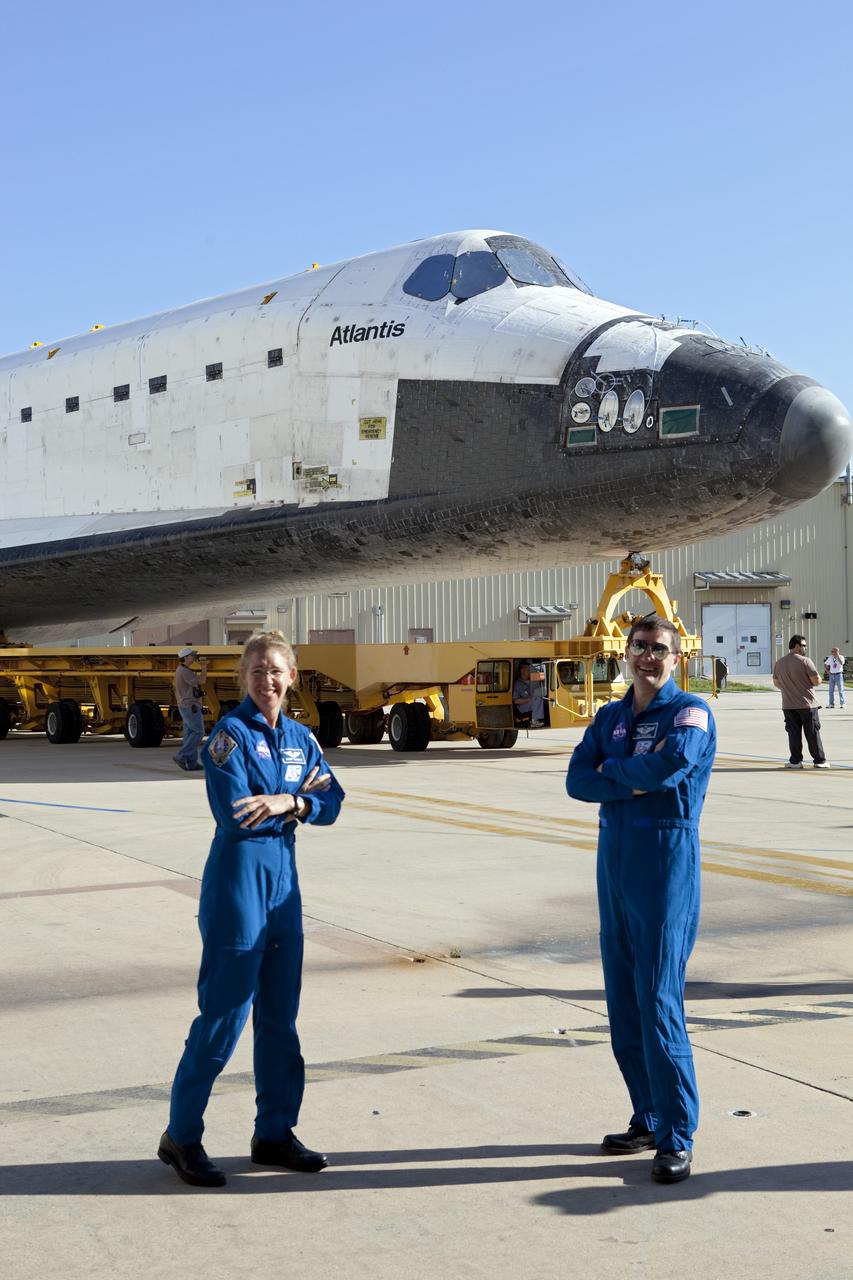 CAPE CANAVERAL, Fla. -- STS-135 Mission Specialists Sandra Magnus and Rex Walheim, pause for a photo while watching shuttle Atlantis' rollover from Orbiter Processing Facility-1 to the Vehicle Assembly Building (VAB) at NASA's Kennedy Space Center in Florida.      The move called "rollover" is a major milestone in processing for the STS-135 mission to the International Space Station. Inside the VAB, the shuttle will be attached to its external fuel tank and solid rocket boosters. Commander Chris Ferguson, Pilot Doug Hurley and Mission Specialists Sandra Magnus and Rex Walheim are expected to launch in mid July, taking with them the Raffaello multipurpose logistics module packed with supplies, logistics and spare parts. The STS-135 mission also will fly a system to investigate the potential for robotically refueling existing spacecraft and return a failed ammonia pump module to help NASA better understand the failure mechanism and improve pump designs for future systems. STS-135 will be the 33rd flight of Atlantis, the 37th shuttle mission to the space station, and the 135th and final mission of NASA's Space Shuttle Program. For more information visit, www.nasa.gov/mission_pages/shuttle/shuttlemissions/sts135/index.html. Photo credit: NASA/Dimitri Gerondidakis