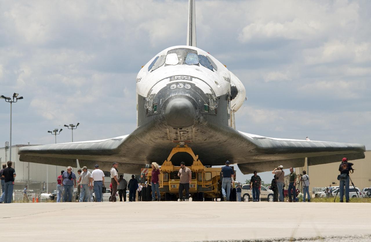 CAPE CANAVERAL, Fla. -- Members of the media and Kennedy workers snap photos of shuttle Atlantis as it makes its final planned move from Orbiter Processing Facility-1 to the Vehicle Assembly Building (VAB) at NASA's Kennedy Space Center in Florida.            The move called "rollover" is a major milestone in processing for the STS-135 mission to the International Space Station. Commander Chris Ferguson, Pilot Doug Hurley and Mission Specialists Sandra Magnus and Rex Walheim are expected to launch mid July, taking with them the Raffaello multipurpose logistics module packed with supplies, logistics and spare parts. The STS-135 mission also will fly a system to investigate the potential for robotically refueling existing spacecraft and return a failed ammonia pump module to help NASA better understand the failure mechanism and improve pump designs for future systems. STS-135 will be the 33rd flight of Atlantis, the 37th shuttle mission to the space station, and the 135th and final mission of NASA's Space Shuttle Program. For more information visit, www.nasa.gov/mission_pages/shuttle/shuttlemissions/sts135/index.html. Photo credit: NASA/Jack Pfaller
