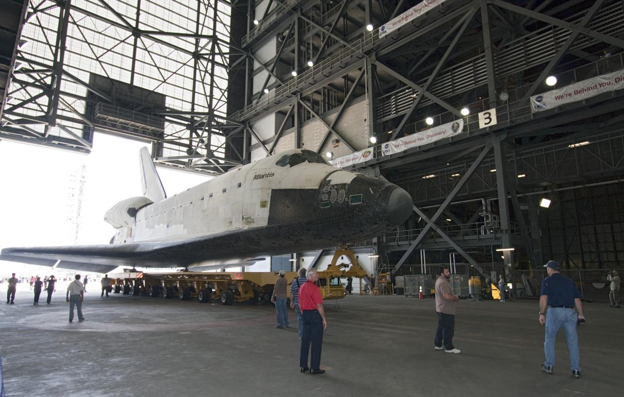 CAPE CANAVERAL, Fla. -- Shuttle Atlantis enters the transfer aisle of the Vehicle Assembly Building (VAB) at NASA's Kennedy Space Center in Florida.    The move called "rollover" is a major milestone in processing for the STS-135 mission to the International Space Station. Commander Chris Ferguson, Pilot Doug Hurley and Mission Specialists Sandra Magnus and Rex Walheim are expected to launch mid July, taking with them the Raffaello multipurpose logistics module packed with supplies, logistics and spare parts. The STS-135 mission also will fly a system to investigate the potential for robotically refueling existing spacecraft and return a failed ammonia pump module to help NASA better understand the failure mechanism and improve pump designs for future systems. STS-135 will be the 33rd flight of Atlantis, the 37th shuttle mission to the space station, and the 135th and final mission of NASA's Space Shuttle Program. For more information visit, www.nasa.gov/mission_pages/shuttle/shuttlemissions/sts135/index.html. Photo credit: NASA/Jack Pfaller