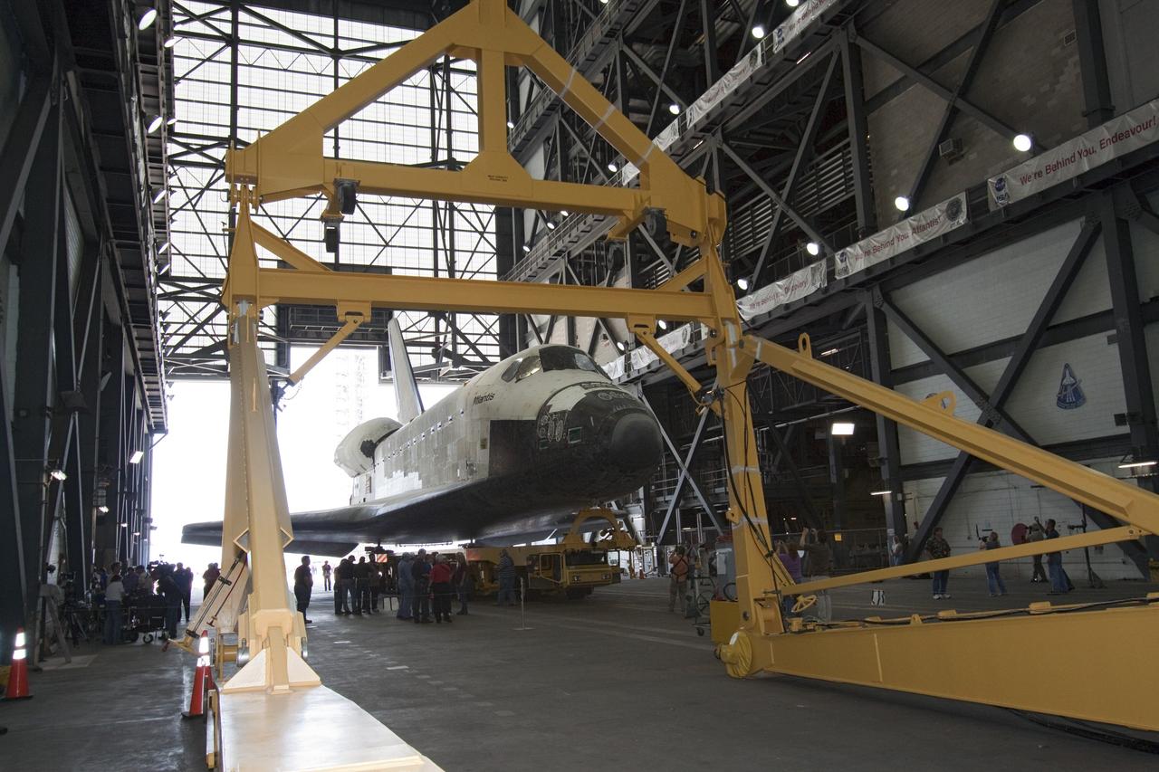 CAPE CANAVERAL, Fla. -- Shuttle Atlantis is parked in the transfer aisle in the Vehicle Assembly Building (VAB) at NASA's Kennedy Space Center in Florida. A large yellow sling device (foreground) will be used to lift Atlantis into a high bay for joining to the solid rocket boosters and external tank already installed on a mobile launcher platform. The move called "rollover" is a major milestone in processing for the STS-135 mission to the International Space Station. Commander Chris Ferguson, Pilot Doug Hurley and Mission Specialists Sandra Magnus and Rex Walheim are expected to launch mid July, taking with them the Raffaello multipurpose logistics module packed with supplies, logistics and spare parts. The STS-135 mission also will fly a system to investigate the potential for robotically refueling existing spacecraft and return a failed ammonia pump module to help NASA better understand the failure mechanism and improve pump designs for future systems. STS-135 will be the 33rd flight of Atlantis, the 37th shuttle mission to the space station, and the 135th and final mission of NASA's Space Shuttle Program. For more information visit, www.nasa.gov/mission_pages/shuttle/shuttlemissions/sts135/index.html. Photo credit: NASA/Jack Pfaller