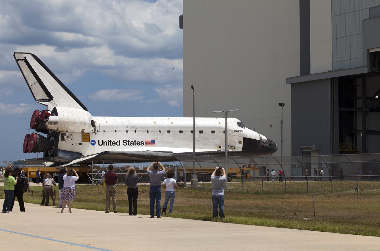 CAPE CANAVERAL, Fla. -- Kennedy workers snap photos of shuttle Atlantis as it makes its final planned move into the Vehicle Assembly Building (VAB) from Orbiter Processing Facility-1 at NASA's Kennedy Space Center in Florida.        The move called "rollover" is a major milestone in processing for the STS-135 mission to the International Space Station. Commander Chris Ferguson, Pilot Doug Hurley and Mission Specialists Sandra Magnus and Rex Walheim are targeted to launch in early July, taking with them the Raffaello multipurpose logistics module packed with supplies, logistics and spare parts. The STS-135 mission also will fly a system to investigate the potential for robotically refueling existing spacecraft and return a failed ammonia nfor future systems. STS-135 will be the 33rd flight of Atlantis, the 37th shuttle mission to the space station, and the 135th and final mission of NASA's Space Shuttle Program. For more information visit, www.nasa.gov/mission_pages/shuttle/shuttlemissions/sts135/index.html. Photo credit: NASA/Frankie Martin