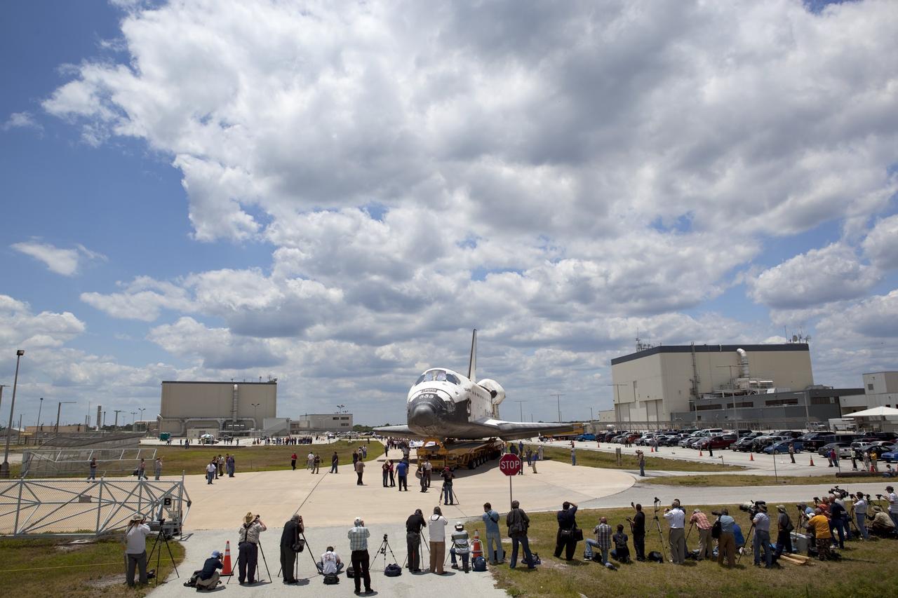 Cape Canaveral, Fla. -- Media and Kennedy employees snap photos of shuttle Atlantis as it makes its final planned move to the Vehicle Assembly Building (VAB) from Orbiter Processing Facility-1 at NASA's Kennedy Space Center in Florida.          The move called "rollover" is a major milestone in processing for the STS-135 mission to the International Space Station. Inside the VAB, the shuttle will be attached to its external fuel tank and solid rocket boosters. Commander Chris Ferguson, Pilot Doug Hurley and Mission Specialists Sandra Magnus and Rex Walheim are targeted to launch in early July, taking with them the Raffaello multipurpose logistics module packed with supplies, logistics and spare parts. The STS-135 mission also will fly a system to investigate the potential for robotically refueling existing spacecraft and return a failed ammonia pump module to help NASA better understand the failure mechanism and improve pump designs for future systems. STS-135 will be the 33rd flight of Atlantis, the 37th shuttle mission to the space station, and the 135th and final mission of NASA's Space Shuttle Program. For more information visit, www.nasa.gov/mission_pages/shuttle/shuttlemissions/sts135/index.html. Photo credit: NASA/Dimitri Gerondidakis