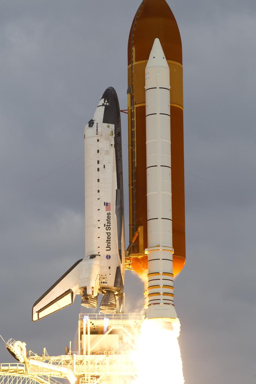 Cape Canaveral, Fla. -- On Launch Pad 39A at NASA's Kennedy Space Center in Florida, space shuttle Endeavour rises past the fixed service structure as it races toward space.        Endeavour began its final flight, the STS-134 mission to the International Space Station, at 8:56 a.m. EDT on May 16. Endeavour and its six-member crew will deliver the Alpha Magnetic Spectrometer-2 (AMS), Express Logistics Carrier-3, a high-pressure gas tank and additional spare parts for the Dextre robotic helper to the space station. For more information visit, www.nasa.gov/mission_pages/shuttle/shuttlemissions/sts134/index.html. Photo credit: NASA/George Roberts and Mike Kerley