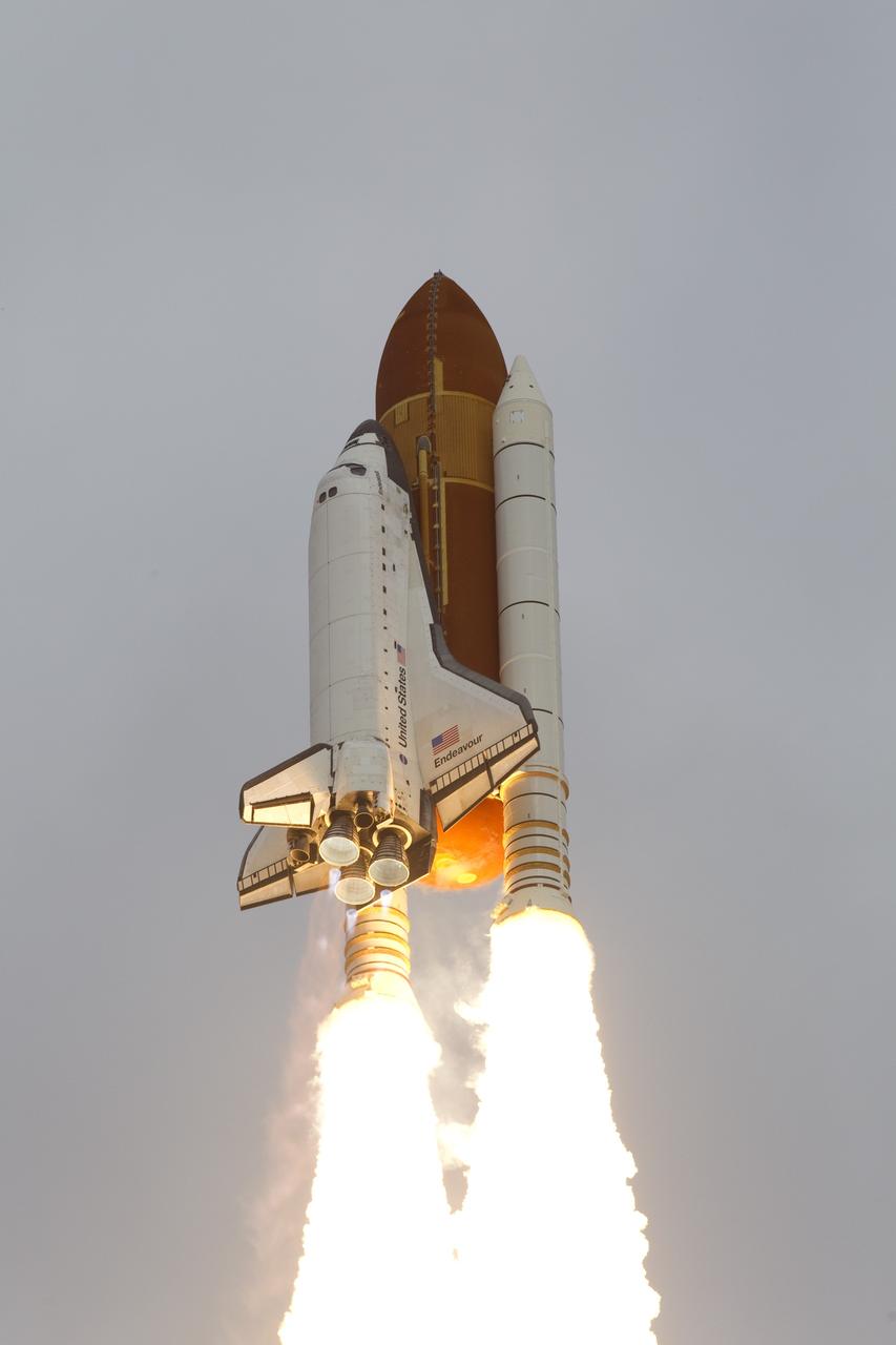 CAPE CANAVERAL, Fla. -- Space shuttle Endeavour soars through the clouds toward orbit after lifting off from Launch Pad 39A at NASA's Kennedy Space Center in Florida.        Endeavour began its final flight, the STS-134 mission to the International Space Station, at 8:56 a.m. EDT on May 16. Endeavour and its six-member crew will deliver the Alpha Magnetic Spectrometer-2 (AMS), Express Logistics Carrier-3, a high-pressure gas tank and additional spare parts for the Dextre robotic helper to the space station. For more information visit, www.nasa.gov/mission_pages/shuttle/shuttlemissions/sts134/index.html. Photo credit: NASA/George Roberts and Mike Kerley