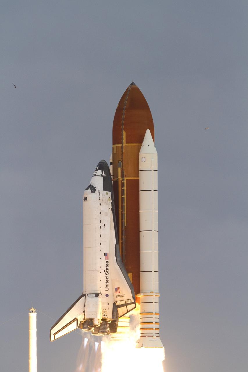 Cape Canaveral, Fla. -- On Launch Pad 39A at NASA's Kennedy Space Center in Florida, space shuttle Endeavour rises above the fixed service structure as it races toward space.      Endeavour began its final flight, the STS-134 mission to the International Space Station, at 8:56 a.m. EDT on May 16. Endeavour and its six-member crew will deliver the Alpha Magnetic Spectrometer-2 (AMS), Express Logistics Carrier-3, a high-pressure gas tank and additional spare parts for the Dextre robotic helper to the space station. For more information visit, www.nasa.gov/mission_pages/shuttle/shuttlemissions/sts134/index.html. Photo credit: NASA/Kenny Allen and George Roberts