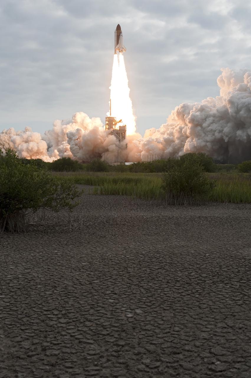 Cape Canaveral, Fla. -- Clouds of smoke and steam fill Launch Pad 39A at NASA's Kennedy Space Center in Florida as space shuttle Endeavour soars into the clouds above atop twin columns of fire.        Endeavour began its final flight, the STS-134 mission to the International Space Station, at 8:56 a.m. EDT on May 16. Endeavour and its six-member crew will deliver the Alpha Magnetic Spectrometer-2 (AMS), Express Logistics Carrier-3, a high-pressure gas tank and additional spare parts for the Dextre robotic helper to the space station. For more information visit, www.nasa.gov/mission_pages/shuttle/shuttlemissions/sts134/index.html. Photo credit: NASA/Tony Gray and Tom Farrar