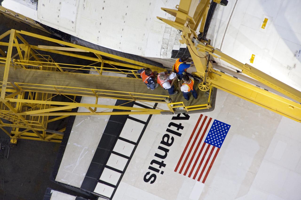 CAPE CANAVERAL, Fla. -- This overhead view photographed in the Vehicle Assembly Building at NASA's Kennedy Space Center in Florida, shows workers attaching a crane to shuttle Atlantis. The crane will lift the spacecraft into a high bay where it will be attached to the waiting external fuel tank and solid rocket boosters, which are already on the mobile launcher platform. Commander Chris Ferguson, Pilot Doug Hurley and Mission Specialists Sandra Magnus and Rex Walheim are targeted to launch in early July, taking with them the Raffaello multi-purpose logistics module packed with supplies, logistics and spare parts. The STS-135 mission also will fly a system to investigate the potential for robotically refueling existing spacecraft and return a failed ammonia pump module to help NASA better understand the failure mechanism and improve pump designs for future systems. STS-135 will be the 33rd flight of Atlantis, the 37th shuttle mission to the space station, and the 135th and final mission of NASA's Space Shuttle Program. For more information visit, www.nasa.gov/mission_pages/shuttle/shuttlemissions/sts135/index.html. Photo credit: NASA/Ken Thornsley