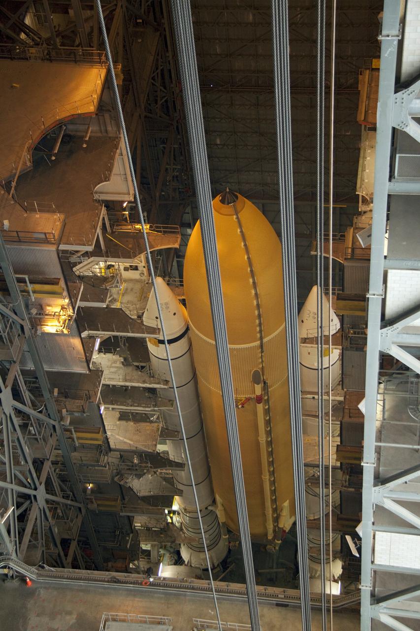 CAPE CANAVERAL, Fla. -- This overhead view in the Vehicle Assembly Building at NASA's Kennedy Space Center in Florida shows the STS-135 external fuel tank and solid rocket boosters already installed on the mobile launcher platform waiting for shuttle Atlantis to make the stack complete. Commander Chris Ferguson, Pilot Doug Hurley and Mission Specialists Sandra Magnus and Rex Walheim are expected to launch in mid-July, taking with them the Raffaello multi-purpose logistics module packed with supplies, logistics and spare parts. The STS-135 mission also will fly a system to investigate the potential for robotically refueling existing spacecraft and return a failed ammonia pump module to help NASA better understand the failure mechanism and improve pump designs for future systems. STS-135 will be the 33rd flight of Atlantis, the 37th shuttle mission to the space station, and the 135th and final mission of NASA's Space Shuttle Program. For more information visit, www.nasa.gov/mission_pages/shuttle/shuttlemissions/sts135/index.html. Photo credit: NASA/Jack Pfaller