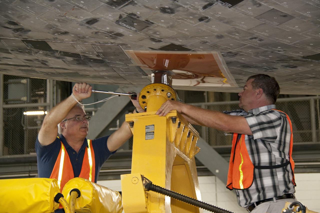 CAPE CANAVERAL, Fla. -- In the Vehicle Assembly Building at NASA's Kennedy Space Center in Florida, workers disconnect the transporter from shuttle Atlantis. An overhead crane then will lift the spacecraft into a high bay where it will be attached to its external fuel tank and solid rocket boosters already on the mobile launcher platform. Commander Chris Ferguson, Pilot Doug Hurley and Mission Specialists Sandra Magnus and Rex Walheim are expected to launch in mid-July, taking with them the Raffaello multi-purpose logistics module packed with supplies, logistics and spare parts. The STS-135 mission also will fly a system to investigate the potential for robotically refueling existing spacecraft and return a failed ammonia pump module to help NASA better understand the failure mechanism and improve pump designs for future systems. STS-135 will be the 33rd flight of Atlantis, the 37th shuttle mission to the space station, and the 135th and final mission of NASA's Space Shuttle Program. For more information visit, www.nasa.gov/mission_pages/shuttle/shuttlemissions/sts135/index.html. Photo credit: NASA/Jack Pfaller