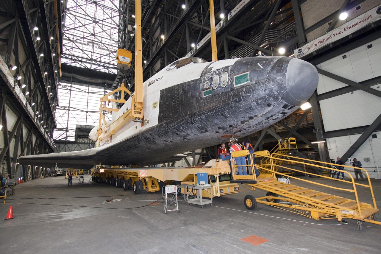 CAPE CANAVERAL, Fla. -- In the Vehicle Assembly Building at NASA's Kennedy Space Center in Florida, workers disconnect the transporter from shuttle Atlantis. An overhead crane then will lift the spacecraft into a high bay where it will be attached to its external fuel tank and solid rocket boosters already on the mobile launcher platform. Commander Chris Ferguson, Pilot Doug Hurley and Mission Specialists Sandra Magnus and Rex Walheim are expected to launch in mid-July, taking with them the Raffaello multi-purpose logistics module packed with supplies, logistics and spare parts. The STS-135 mission also will fly a system to investigate the potential for robotically refueling existing spacecraft and return a failed ammonia pump module to help NASA better understand the failure mechanism and improve pump designs for future systems. STS-135 will be the 33rd flight of Atlantis, the 37th shuttle mission to the space station, and the 135th and final mission of NASA's Space Shuttle Program. For more information visit, www.nasa.gov/mission_pages/shuttle/shuttlemissions/sts135/index.html. Photo credit: NASA/Jack Pfaller