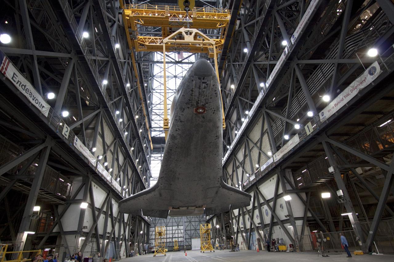 CAPE CANAVERAL, Fla. -- In Vehicle Assembly Building at NASA's Kennedy Space Center in Florida, an overhead crane slowly lifts shuttle Atlantis into a vertical position above the transfer aisle. The spacecraft will be moved to a high bay where it will be attached to its external fuel tank and solid rocket boosters already on the mobile launcher platform. Commander Chris Ferguson, Pilot Doug Hurley and Mission Specialists Sandra Magnus and Rex Walheim are expected to launch in mid-July, taking with them the Raffaello multi-purpose logistics module packed with supplies, logistics and spare parts. The STS-135 mission also will fly a system to investigate the potential for robotically refueling existing spacecraft and return a failed ammonia pump module to help NASA better understand the failure mechanism and improve pump designs for future systems. STS-135 will be the 33rd flight of Atlantis, the 37th shuttle mission to the space station, and the 135th and final mission of NASA's Space Shuttle Program. For more information visit, www.nasa.gov/mission_pages/shuttle/shuttlemissions/sts135/index.html. Photo credit: NASA/Jack Pfaller