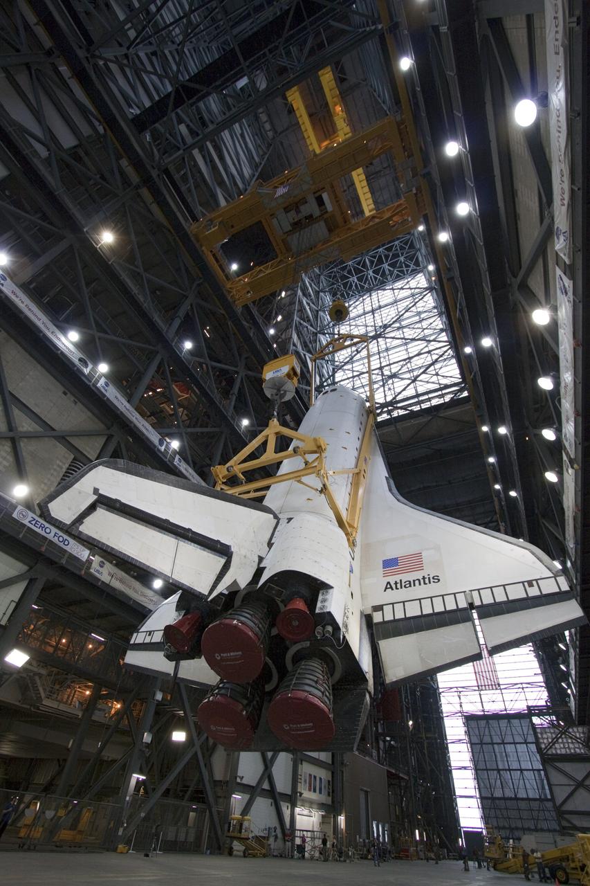 CAPE CANAVERAL, Fla. -- In Vehicle Assembly Building at NASA's Kennedy Space Center in Florida, an overhead crane slowly lifts shuttle Atlantis into a vertical position above the transfer aisle. The spacecraft will be moved to a high bay where it will be attached to its external fuel tank and solid rocket boosters already on the mobile launcher platform. Commander Chris Ferguson, Pilot Doug Hurley and Mission Specialists Sandra Magnus and Rex Walheim are expected to launch in mid-July, taking with them the Raffaello multi-purpose logistics module packed with supplies, logistics and spare parts. The STS-135 mission also will fly a system to investigate the potential for robotically refueling existing spacecraft and return a failed ammonia pump module to help NASA better understand the failure mechanism and improve pump designs for future systems. STS-135 will be the 33rd flight of Atlantis, the 37th shuttle mission to the space station, and the 135th and final mission of NASA's Space Shuttle Program. For more information visit, www.nasa.gov/mission_pages/shuttle/shuttlemissions/sts135/index.html. Photo credit: NASA/Jack Pfaller