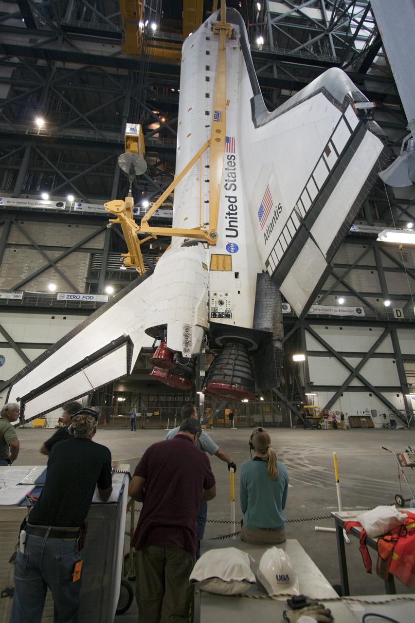 CAPE CANAVERAL, Fla. -- In Vehicle Assembly Building at NASA's Kennedy Space Center in Florida, an overhead crane suspends shuttle Atlantis above the transfer aisle. The spacecraft will be moved into a high bay where it will be lowered and attached to its external fuel tank and solid rocket boosters already on the mobile launcher platform. Commander Chris Ferguson, Pilot Doug Hurley and Mission Specialists Sandra Magnus and Rex Walheim are expected to launch in mid-July, taking with them the Raffaello multi-purpose logistics module packed with supplies, logistics and spare parts. The STS-135 mission also will fly a system to investigate the potential for robotically refueling existing spacecraft and return a failed ammonia pump module to help NASA better understand the failure mechanism and improve pump designs for future systems. STS-135 will be the 33rd flight of Atlantis, the 37th shuttle mission to the space station, and the 135th and final mission of NASA's Space Shuttle Program. For more information visit, www.nasa.gov/mission_pages/shuttle/shuttlemissions/sts135/index.html. Photo credit: NASA/Jack Pfaller