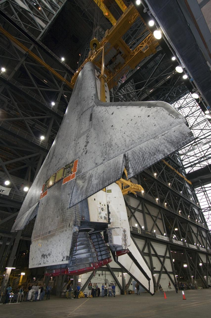 CAPE CANAVERAL, Fla. -- In Vehicle Assembly Building at NASA's Kennedy Space Center in Florida, an overhead crane suspends shuttle Atlantis above the transfer aisle. The spacecraft will be moved into a high bay where it will be lowered and attached to its external fuel tank and solid rocket boosters already on the mobile launcher platform. Commander Chris Ferguson, Pilot Doug Hurley and Mission Specialists Sandra Magnus and Rex Walheim are expected to launch in mid-July, taking with them the Raffaello multi-purpose logistics module packed with supplies, logistics and spare parts. The STS-135 mission also will fly a system to investigate the potential for robotically refueling existing spacecraft and return a failed ammonia pump module to help NASA better understand the failure mechanism and improve pump designs for future systems. STS-135 will be the 33rd flight of Atlantis, the 37th shuttle mission to the space station, and the 135th and final mission of NASA's Space Shuttle Program. For more information visit, www.nasa.gov/mission_pages/shuttle/shuttlemissions/sts135/index.html. Photo credit: NASA/Jack Pfaller