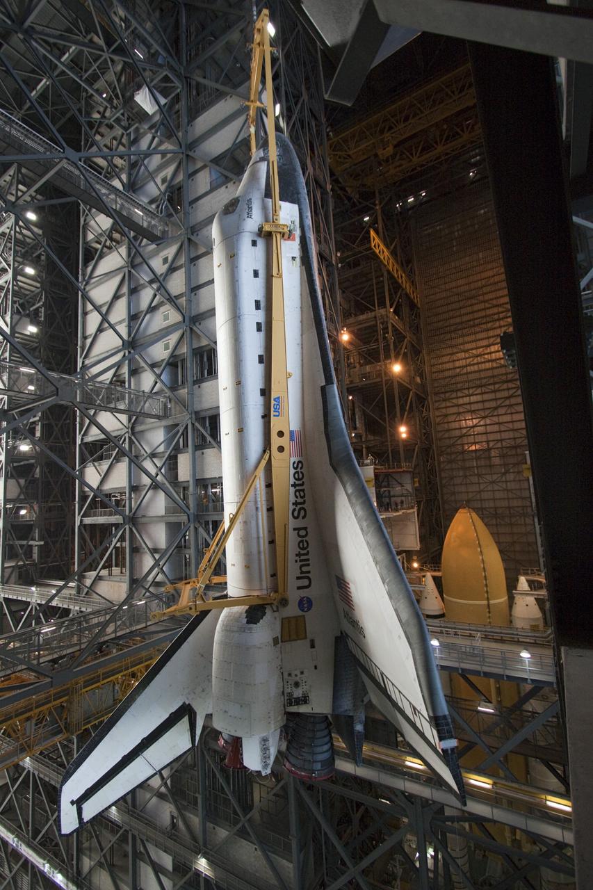 CAPE CANAVERAL, Fla. -- In the Vehicle Assembly Building at NASA's Kennedy Space Center in Florida, shuttle Atlantis is lifted by an overhead crane and moved into a high bay where it will be attached to its external fuel tank and solid rocket boosters already on the mobile launcher platform. Commander Chris Ferguson, Pilot Doug Hurley and Mission Specialists Sandra Magnus and Rex Walheim are expected to launch in mid-July, taking with them the Raffaello multi-purpose logistics module packed with supplies, logistics and spare parts. The STS-135 mission also will fly a system to investigate the potential for robotically refueling existing spacecraft and return a failed ammonia pump module to help NASA better understand the failure mechanism and improve pump designs for future systems. STS-135 will be the 33rd flight of Atlantis, the 37th shuttle mission to the space station, and the 135th and final mission of NASA's Space Shuttle Program. For more information visit, www.nasa.gov/mission_pages/shuttle/shuttlemissions/sts135/index.html. Photo credit: NASA/Troy Cryder
