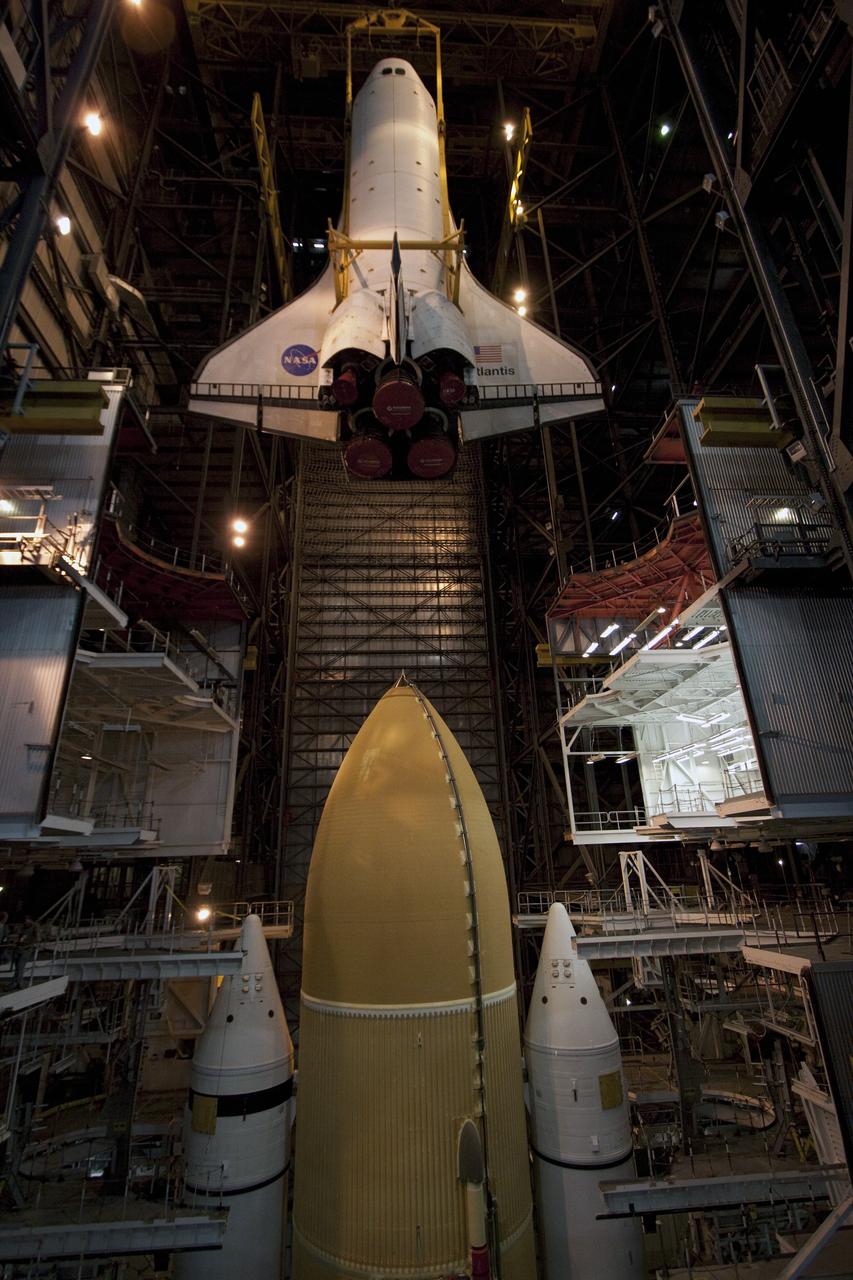 CAPE CANAVERAL, Fla. -- In the Vehicle Assembly Building at NASA's Kennedy Space Center in Florida, shuttle Atlantis is lowered by an overhead crane into a high bay where it will be attached to its external fuel tank and solid rocket boosters already on the mobile launcher platform. Commander Chris Ferguson, Pilot Doug Hurley and Mission Specialists Sandra Magnus and Rex Walheim are expected to launch in mid-July, taking with them the Raffaello multi-purpose logistics module packed with supplies, logistics and spare parts. The STS-135 mission also will fly a system to investigate the potential for robotically refueling existing spacecraft and return a failed ammonia pump module to help NASA better understand the failure mechanism and improve pump designs for future systems. STS-135 will be the 33rd flight of Atlantis, the 37th shuttle mission to the space station, and the 135th and final mission of NASA's Space Shuttle Program. For more information visit, www.nasa.gov/mission_pages/shuttle/shuttlemissions/sts135/index.html. Photo credit: NASA/Troy Cryder