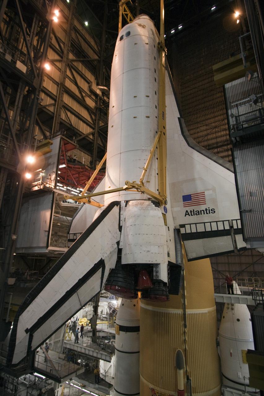 CAPE CANAVERAL, Fla. -- In the Vehicle Assembly Building at NASA's Kennedy Space Center in Florida, shuttle Atlantis is lowered by an overhead crane into a high bay where it will be attached to its external fuel tank and solid rocket boosters already on the mobile launcher platform. Commander Chris Ferguson, Pilot Doug Hurley and Mission Specialists Sandra Magnus and Rex Walheim are expected to launch in mid-July, taking with them the Raffaello multi-purpose logistics module packed with supplies, logistics and spare parts. The STS-135 mission also will fly a system to investigate the potential for robotically refueling existing spacecraft and return a failed ammonia pump module to help NASA better understand the failure mechanism and improve pump designs for future systems. STS-135 will be the 33rd flight of Atlantis, the 37th shuttle mission to the space station, and the 135th and final mission of NASA's Space Shuttle Program. For more information visit, www.nasa.gov/mission_pages/shuttle/shuttlemissions/sts135/index.html. Photo credit: NASA/Troy Cryder