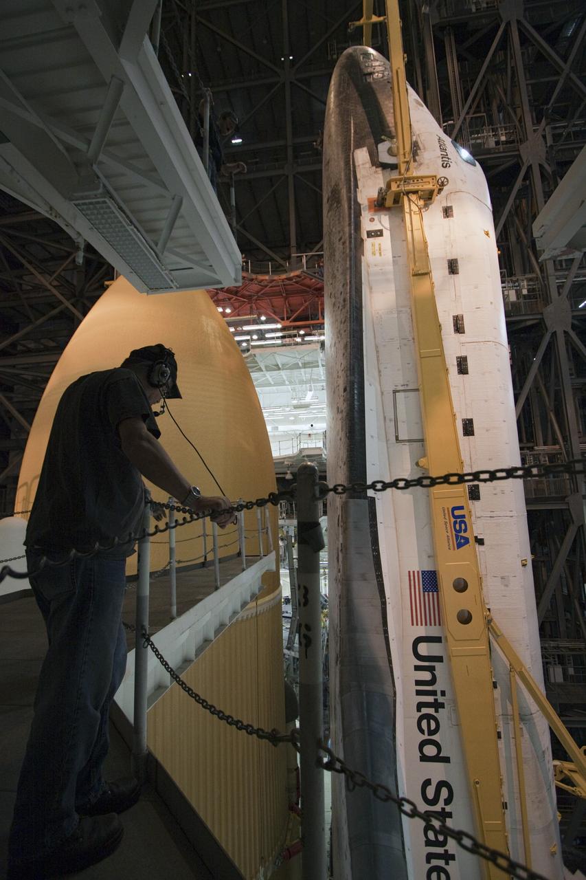 CAPE CANAVERAL, Fla. -- In the Vehicle Assembly Building at NASA's Kennedy Space Center in Florida, a worker monitors the progress of shuttle Atlantis as it is lowered onto the mobile launcher platform where it will be joined with its external fuel tank and solid rocket boosters. Commander Chris Ferguson, Pilot Doug Hurley and Mission Specialists Sandra Magnus and Rex Walheim are expected to launch in mid-July, taking with them the Raffaello multi-purpose logistics module packed with supplies, logistics and spare parts. The STS-135 mission also will fly a system to investigate the potential for robotically refueling existing spacecraft and return a failed ammonia pump module to help NASA better understand the failure mechanism and improve pump designs for future systems. STS-135 will be the 33rd flight of Atlantis, the 37th shuttle mission to the space station, and the 135th and final mission of NASA's Space Shuttle Program. For more information visit, www.nasa.gov/mission_pages/shuttle/shuttlemissions/sts135/index.html. Photo credit: NASA/Troy Cryder