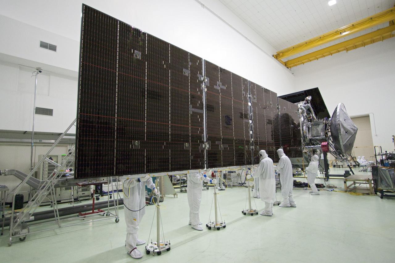 CAPE CANAVERAL, Fla. -- In a clean-room environment at Astrotech's payload processing facility in Titusville, Fla. technicians prepare solar array panels on NASA's Juno spacecraft for illumination testing.        Juno is scheduled to launch aboard a United Launch Alliance Atlas V rocket from Cape Canaveral, Fla. Aug. 5.The solar-powered spacecraft will orbit Jupiter's poles 33 times to find out more about the gas giant's origins, structure, atmosphere and magnetosphere and investigate the existence of a solid planetary core. For more information visit: www.nasa.gov/juno. Photo credit: NASA/Jack Pfaller